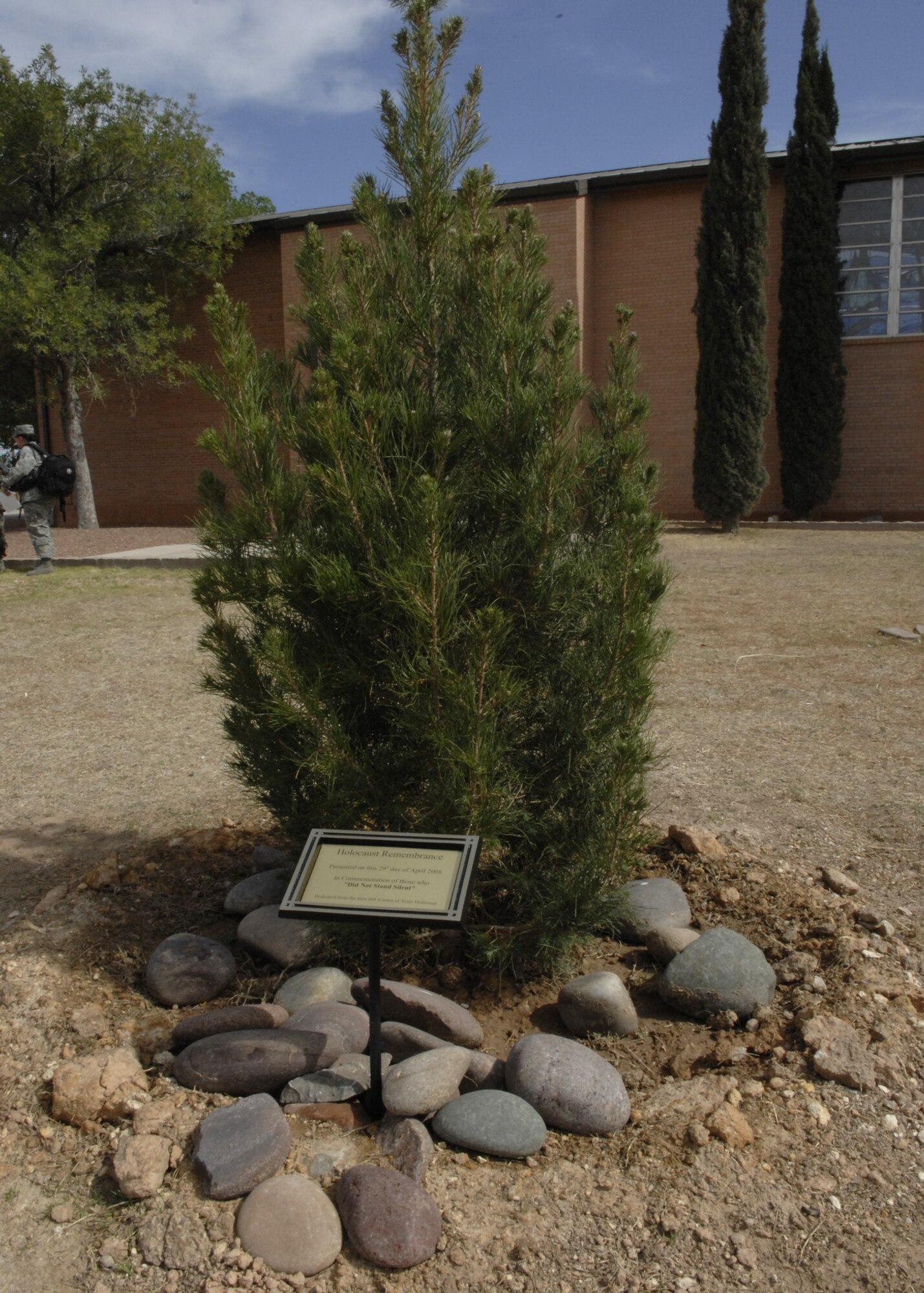 A newly planted tree and plaque sit in front of the base chapel here April 29. The tree was dedicated in honor of "Those who did not stand silent." (U.S. Air Force photo/Airman 1st Class Rachel A. Kocin)