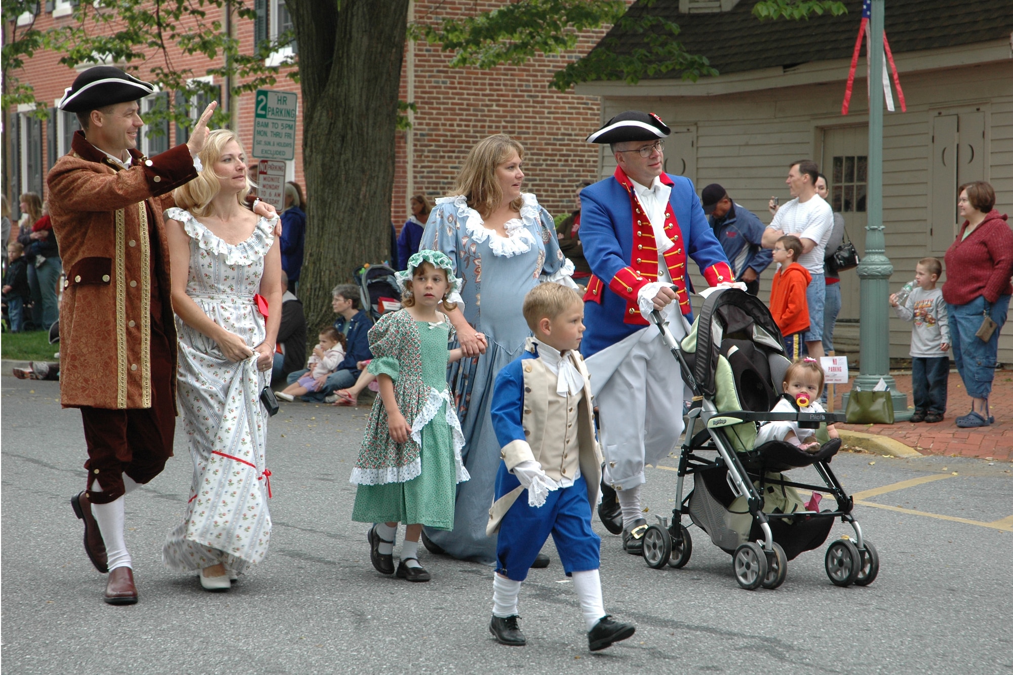 From right, 512th Airlift Wing Commander Col. Randal L. Bright, wife Amy, and their  children, Lauren, 9 months, Garrett, 5, and Hayden, 7, walk with 436th Airlift Wing Commander Col. Steven B. Harrison, left, and his wife Jill in the Old Dover Days parade May 3 at The Green in historic downtown Dover. This was the 75th anniversary of the event, which celebrates the First State's Capital City and featured a parade, maypole dancing, food court, reenactors, walking tours and free entertainment. (U.S. Air Force photo/Capt. Marnee A.C. Losurdo)