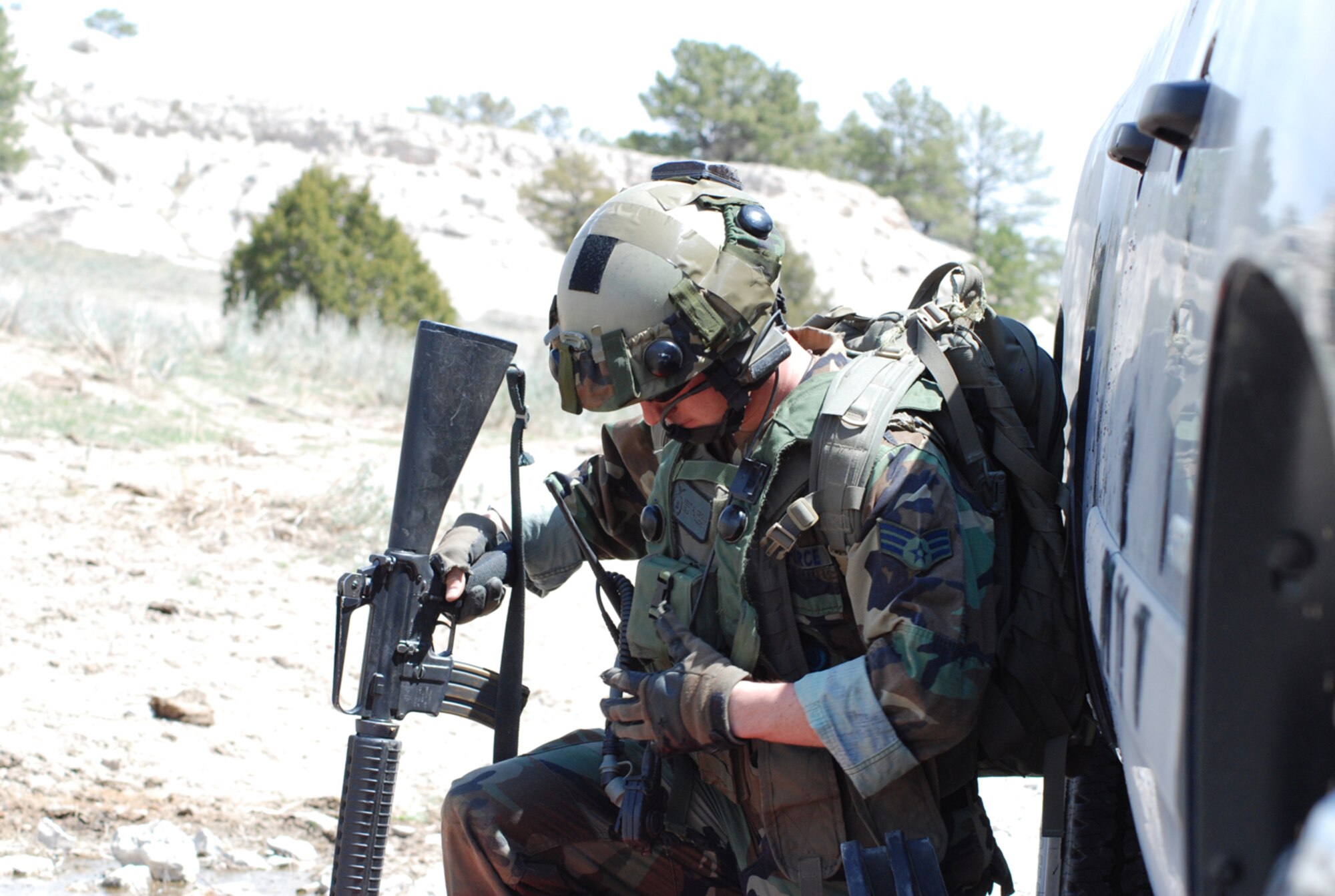 Senior Airman Jorge Richardson, 90th Security Forces Squadron, secures the classified material during the Guardian Challenge event. The security forces Airmen had to traverse difficult terrain and fight off the eight OPFOR members in order to achieve their objective.