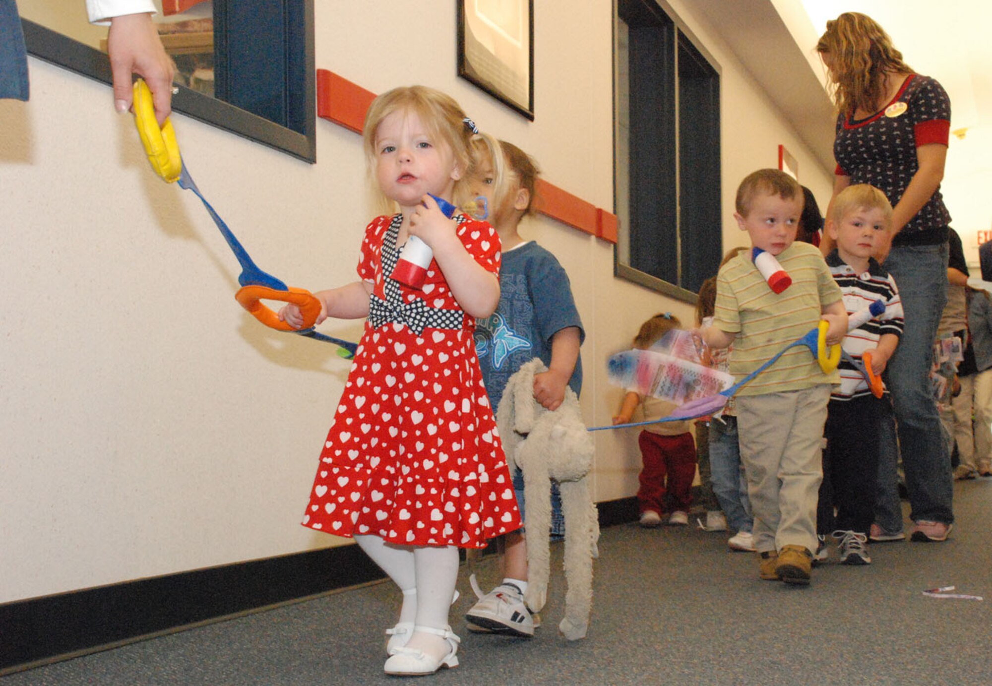 Spencer Love, Peyton York and Christopher Barto lead the line as the parade moves along the hallways of the child development center. The CDC employees constructed ropes so that the children could follow along. After the parade, the CDC staff handed out pamphlets on upcoming events.
