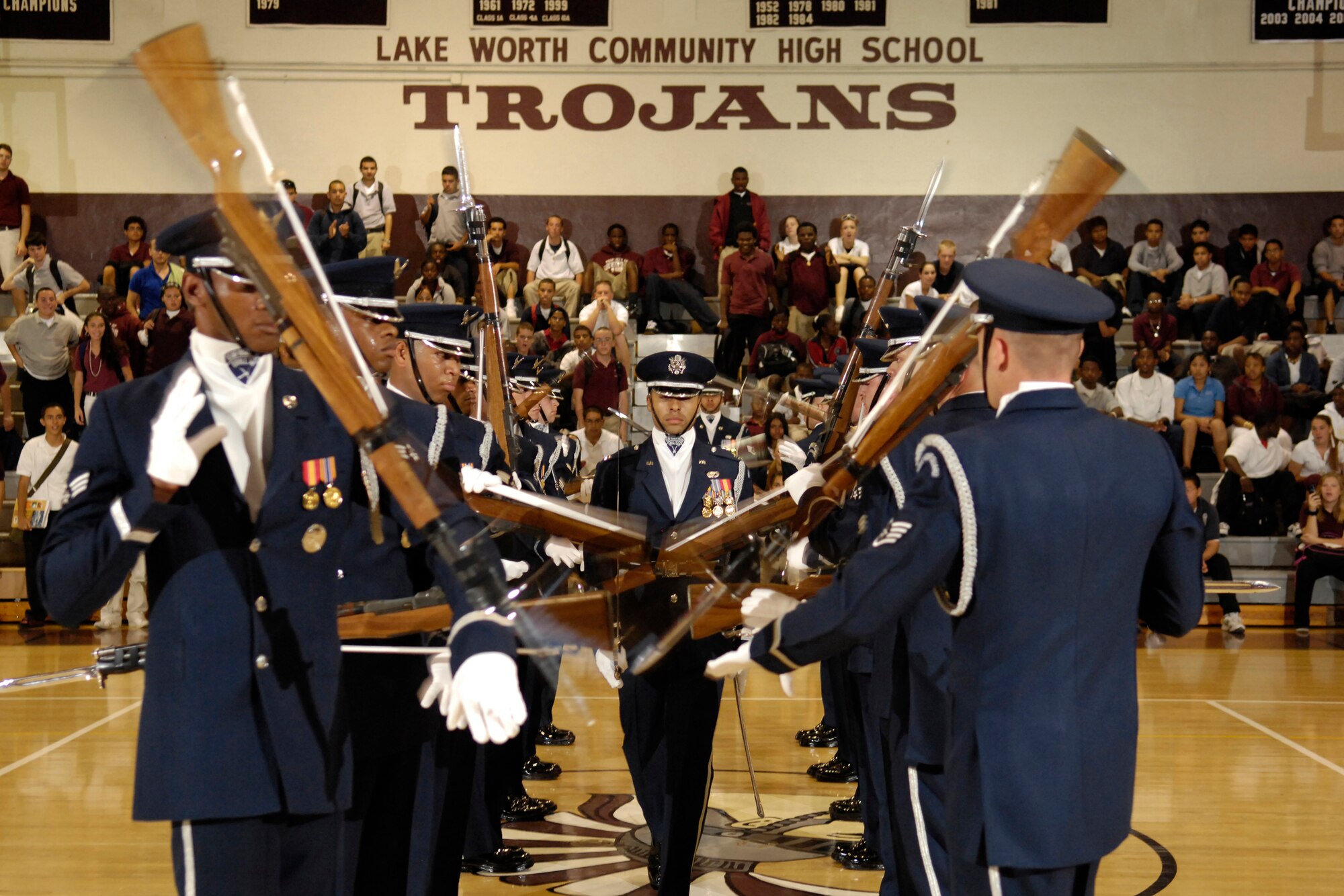 The Air Force Honor Guard Drill Team performs the "guantlet" sequence during a 16-man routine at Lake Worth Community High School in Lake Worth, Fla. 2 May. The team joined local AF recruiters visiting Florida high schools before performing for JROTC cadets at the National High School Drill Team Competition. The Drill Team is the traveling component of the Air Force Honor Guard and tours world-wide representing all Airmen and showcasing USAF precision to recruit, retain, and inspire for the Air Force mission. (U.S. Air Force photo by Senior Airman Dan DeCook)(Released)