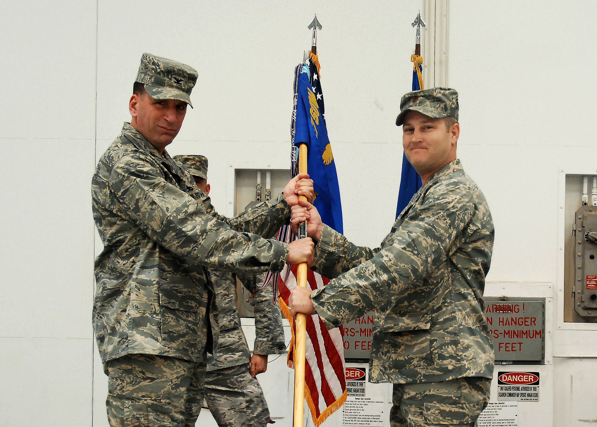 CANNON AIR FORCE BASE, N.M. -  Maj. Andrew Young (right) assumes command of the 27th Special Operations Component Maintenance Squadron from Col. Mark LaRose, 27th Special Operations Maintenance Group commander, in a change-of-command ceremony May 2. Maj. Ryan Rowe relinquished command of the 27th SOCMS. (U.S. Air Force photo/Airman 1st Class Liliana Moreno)