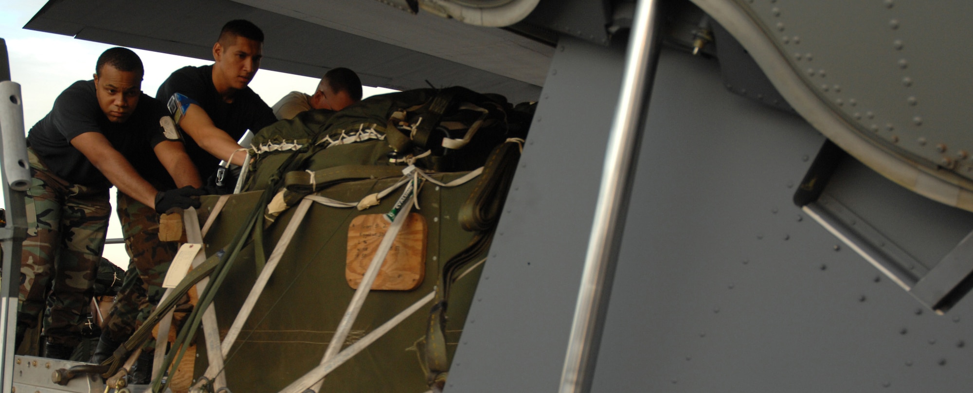 CANNON AIR FORCE BASE, N.M.-- Senior Airman Tristan Banks, 27th Special Operations Logistics Readiness Squadron (left), loads a pallet onto a MC-130W in preparation of a night flying exercise April 30. The MC-130W performs missions primarily at night to reduce operational risk. (U.S. Air Force photo/Airman 1st Class Evelyn Chavez)