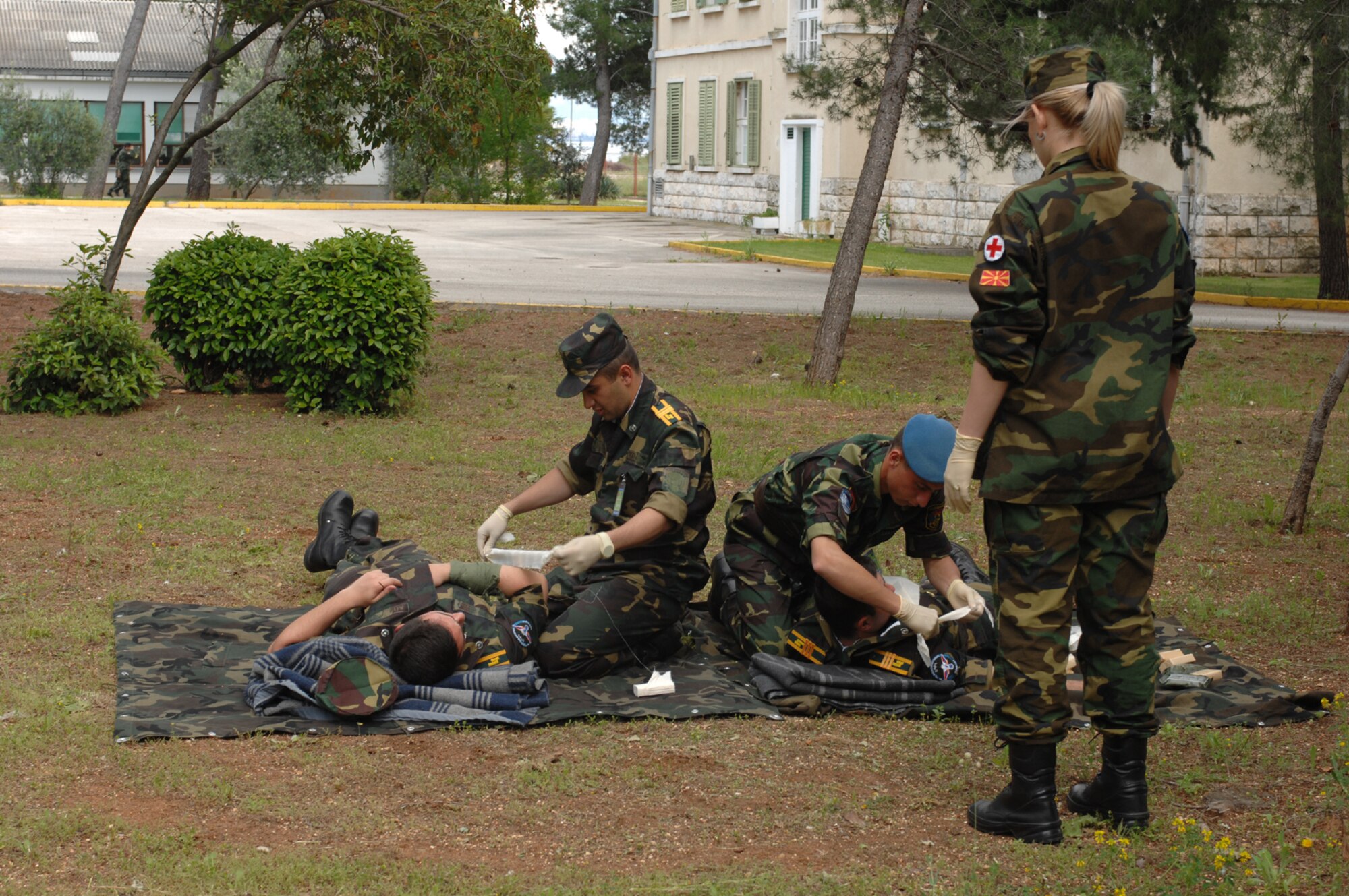 DIVULJE TRAINING BASE, Croatia – Macedonian Army Sgt. Milena Velickovska observes cadets from the Military Medicine Faculty of the Armenian Medical University as they treat each other using Self Aid Buddy Care May 3 during the 2008 Medical Training Exercise in Central and Eastern Europe (MEDCEUR).  The Self Aid Buddy Care course is one of eleven courses offered during MEDCEUR.  Fifteen nations are participating in the exercise from May 2 through 14. The exercise focuses on mass-casualty training scenarios and humanitarian aid in response to crises situations. MEDCEUR is a Joint Chiefs of Staff regional/multilateral exercise sponsored by U.S. European Command. Croatia is hosting the 2008 exercise which has drawn about 400 multi-nationals in support of the Partnership for Peace initiative. (U.S. Air Force photo/Staff Sgt. Kristin Ruleau) 