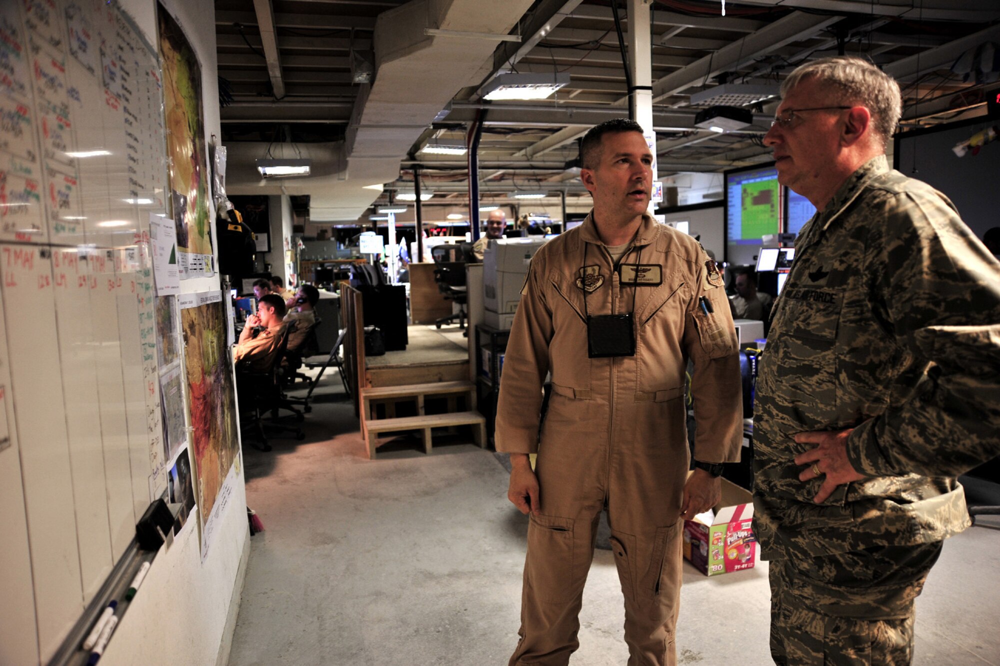 Lt. Col Mark Hersant, Air Mobility Division chief of mobility operations, briefs Gen. Roger Brady, U.S. Air Forces in Europe commander, on-day-to day air mobility operations at the Combined Air and Space Operations Center  in Southwest Asia. General Brady visited the CAOC on his way to other bases in the area of responsibility to meet with deployed Airmen from USAFE. (U.S. Air Force Photo by: Staff Sgt. Christina M. Styer) (RELEASED)*
