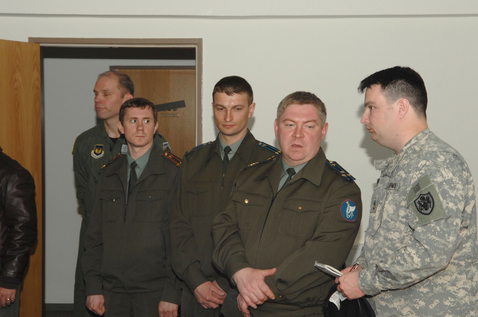 Lt. Col. Dennis Kondrashkin, Lt. Col. Sergey Izkenekov, and Colonel Aleksandu Razygraeu, all from the Russian air forces, were provided translation of a briefing by Sgt. 1st Class Russel Cushman during their visit to the Joint Fighter's Center for Excellence at Spangdahlem AB, Germany, April 30, 2008. (United States Air Force Photo by Senior Airman Logan Tuttle)