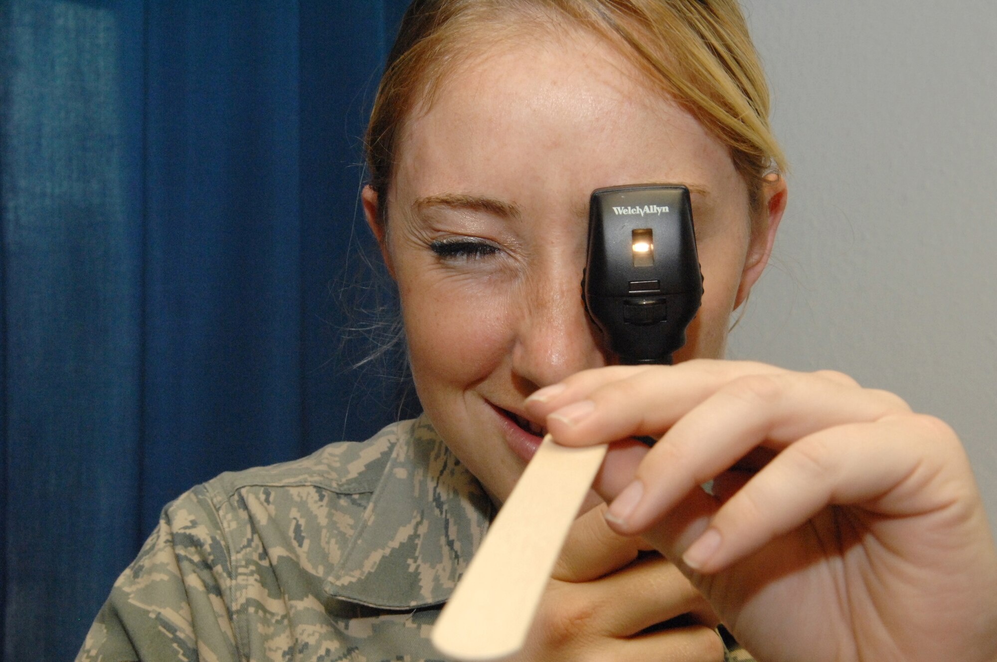 SPANGDAHLEM AIR BASE, Germany -- Senior Airman Macey Miller, 52nd Aerospace Medicine Squadron, uses a tongue depressor during nurse’s appreciation week April 30, 2008.  Nurses appreciation week was a week designed to recognize the efforts of the nurses and technicians that work here.  (U.S. Air Force photo by Senior Airman Logan Tuttle)
