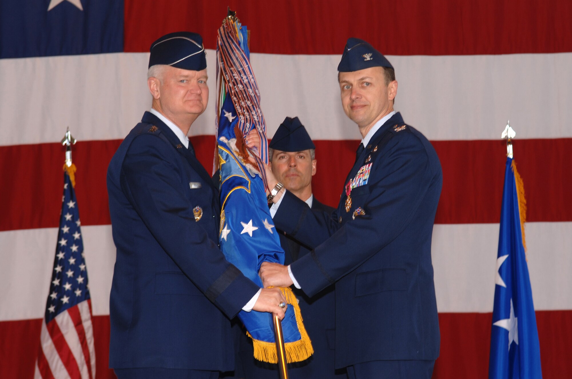 Col. Earl Matthews, 435th Air Base Wing commander, relinquishes command to Lt. Gen. Rod Bishop, 3rd Air Force commander, while Chief Master Sgt. Dave Spector, 435th ABW command chief looks on May 2 at a ceremony in H-3 on Ramstein. (U.S. Air Force Photo by Airman 1st Class Tony Ritter) (Released)

