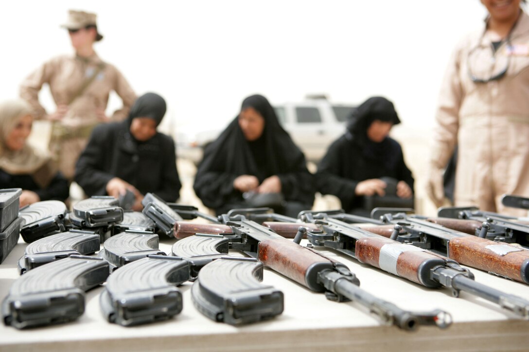 Iraqi women prepare to participate in a practice shoot using AK-47 rifles on a range in Fallujah, Iraq, April 29, 2008. The women are part of a group that is training to join "Sisters of Fallujah," a security force comprised of local women that help maintain security in their neighborhoods. To rebalance the shift in coalition manpower and further transition the role of security from coalition forces to Iraqi Police, the 5th Marine Regiment's 3rd Battalion started the Sisters of Fallujah so that Iraqi women could assist in security operations to search other Iraqi women entering the city through entry control points. 