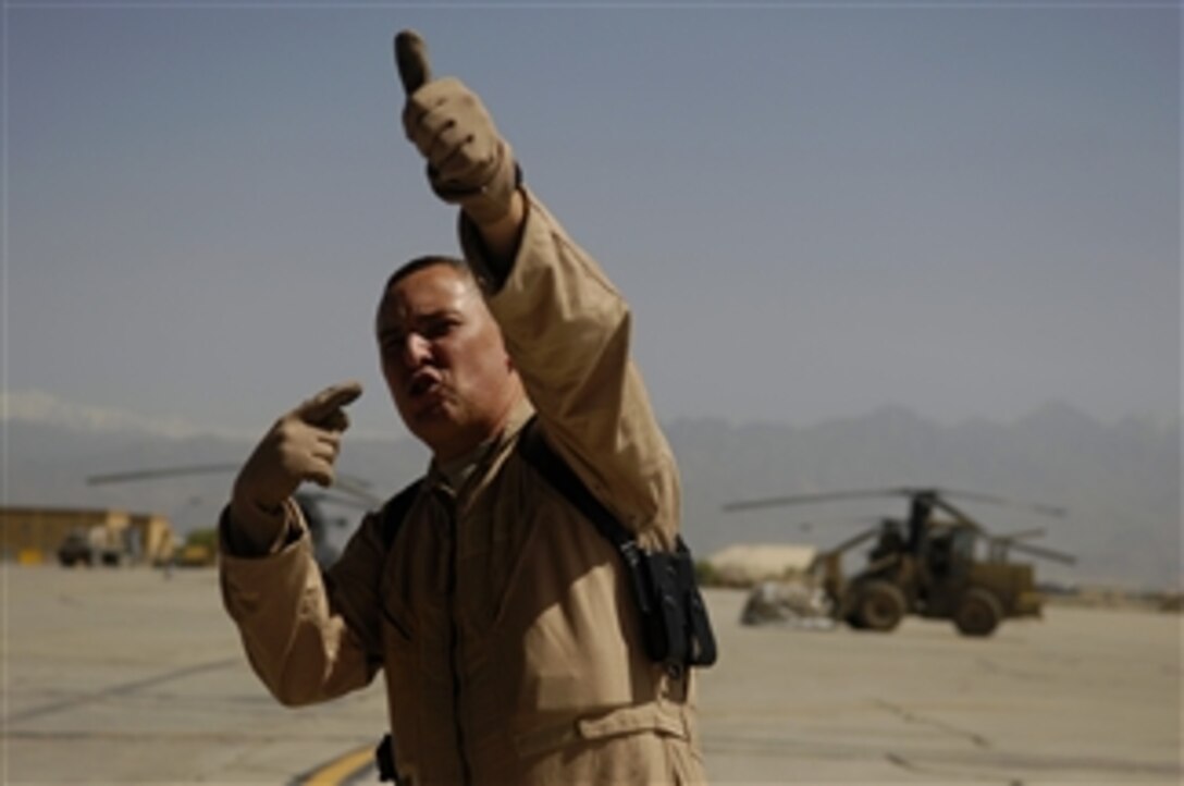 U.S. Air Force Senior Airman Raul Linares directs cargo coming off a C-130J Hercules aircraft at Bagram Air Field, Afghanistan, on May 1, 2008.  Linares is a loadmaster assigned to the 774th Expeditionary Airlift Squadron and deployed from the 115th Airlift Squadron, Channel Island Air National Guard Station, California Air National Guard, Port Hueneme, Calif.  