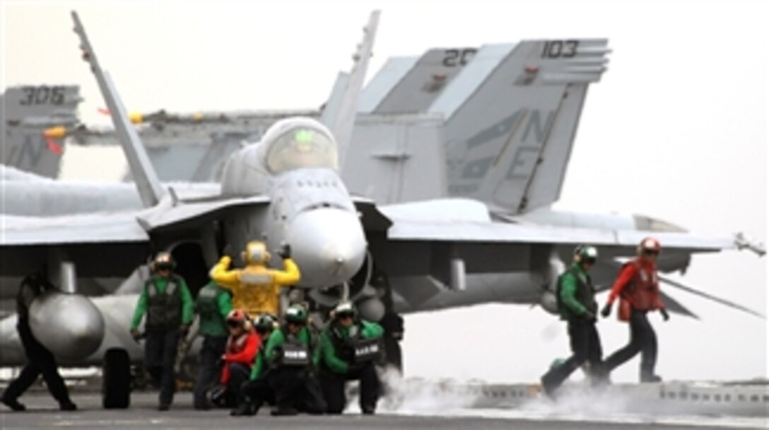 An F/A-18C Hornet is readied for launch on the flight deck of the USS Abraham Lincoln, under way in the Persian Gulf, April 30, 2008. 