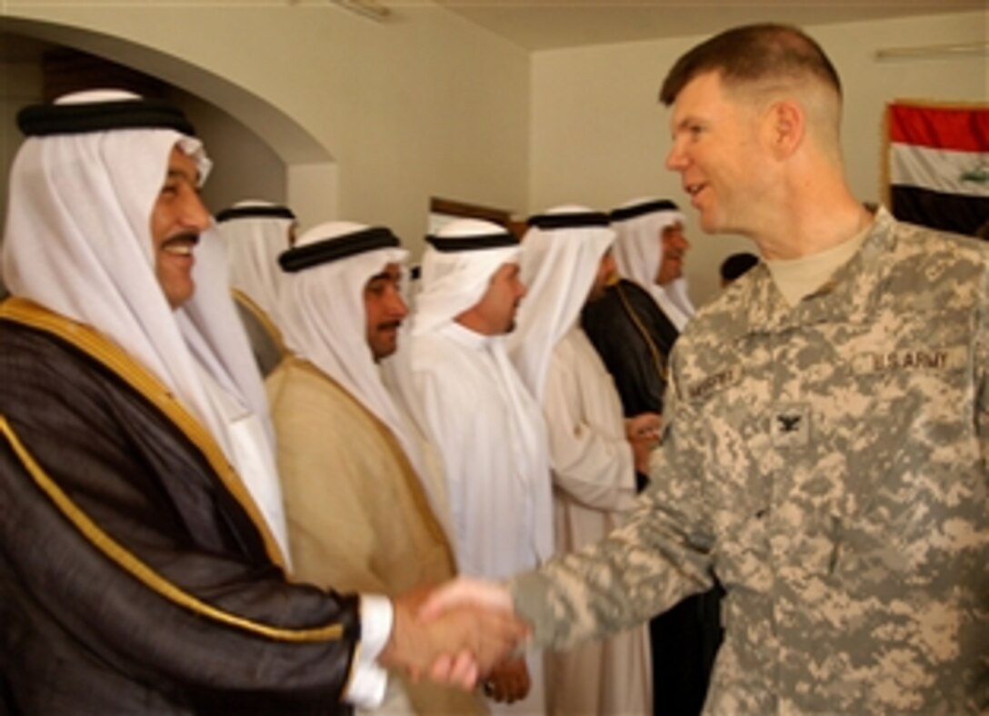A leader of the Sons of Iraq, a citizen security group, greets U.S. Army Col. Todd McCaffrey May 3, 2008, at the sheik support center in Taji Qada, northwest of Baghdad. The leaders gathered to sign a contract promising to maintain security through at checkpoints manned by Sons of Iraq members. McCaffrey is commander, 2nd Stryker Brigade Combat Team "Warrior," 25th Infantry Division, Multi-National Division - Baghdad. 

