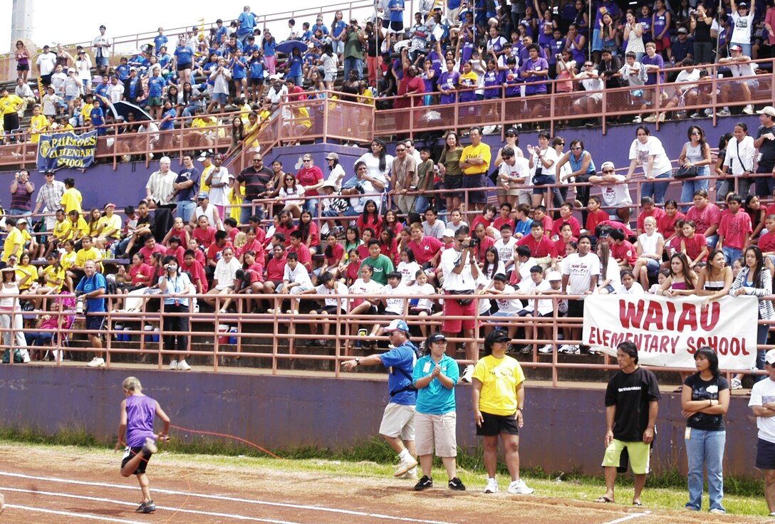 Riggs Napoleon, Pearl City Elementary 5th grader, crosses the finish line in first place during the 4x200 meter relay at Pearl City High School's athletic facility May 5.  This victory helped his school grab first place overall for the fourth consecutive year at an annual field meet against seven other local elementary schools.