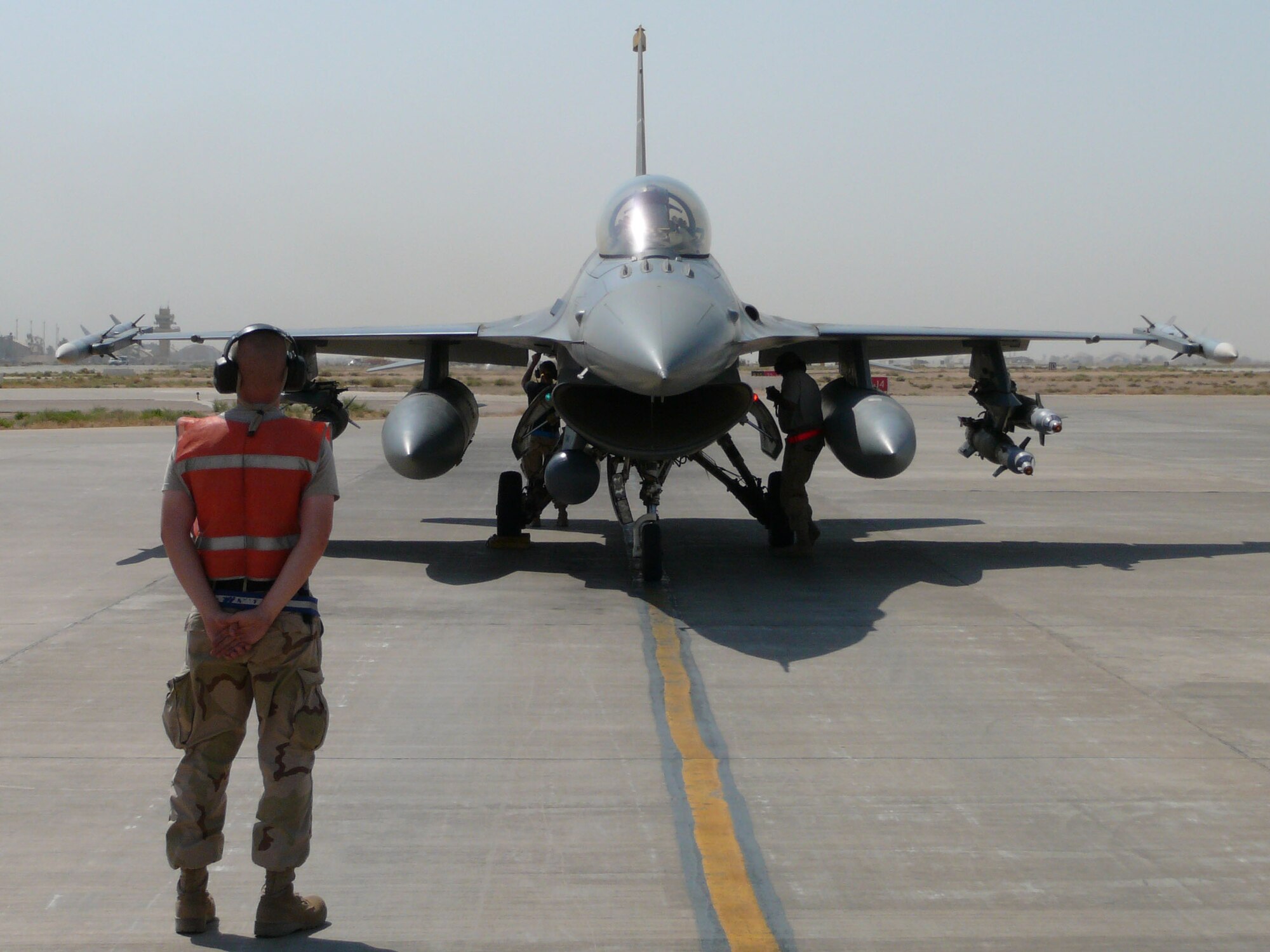 A 13th Expeditionary Fighter Squadron jet sits at the end of the runway at Balad Air Base, Iraq, before a crew chief marshalls the jet out for launch. (Courtesy photo)