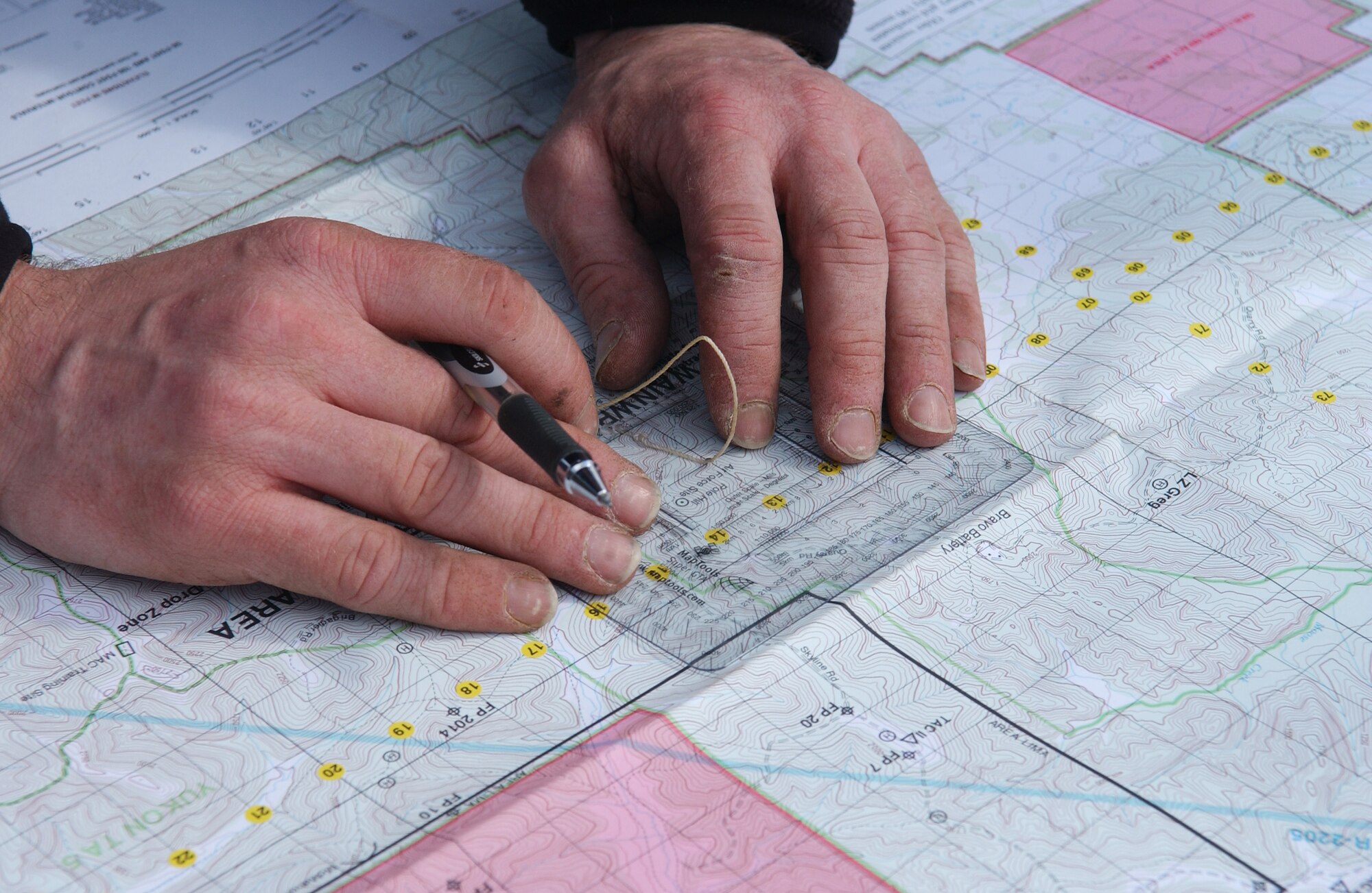 Tech. Sgt. Kelly Totten finds a location on a map using coordinates given to him during land navigation training May 5, 2008, at Eielson Air Force Base, Alaska. Northern Edge 08 exercise is Alaska's premier joint training exercise designed to practice operations, techniques and procedures, and enhance interoperability among the services ranging from Airmen, Soldiers, Sailors, Marines, Coast Guardsmen and Civilian emergency response teams. Sergeant Totten is a Tactical Air Control Party Airman assigned to Detachment 1, 3rd Air Support Operation Squadron from Fort Richardson, Alaska. (U.S. Air Force Photo/Airman 1st Class Jonathan Snyder) 