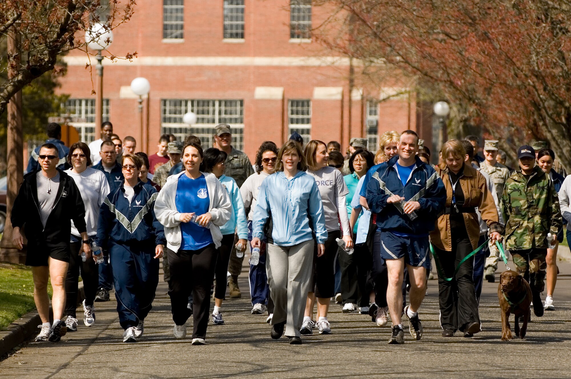 McChord’s Sexual Assault Response Coordinator Heather Van Mill, center, and Lt. Col. Brian Newberry, 7th Airlift Squadron commander, right, lead the April 25 “Walk to End Sexual Violence.” The annual walk down Tuskegee Airman Boulevard was part of Sexual Assault Awareness Month activities.