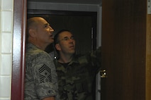 MINOT AIR FORCE BASE N.D. -- Tech. Sgt. Brian Eggers, central dorm manager, shows Chief Master Sgt. Stephen Sullens, Air Combat Command's command chief master sgt., the Airmen?s dormitories here, April 29. This is Chief Sullens' first visit to Minot as ACC command chief. (U.S. Air Force photo by Senior Airman Joe Rivera)