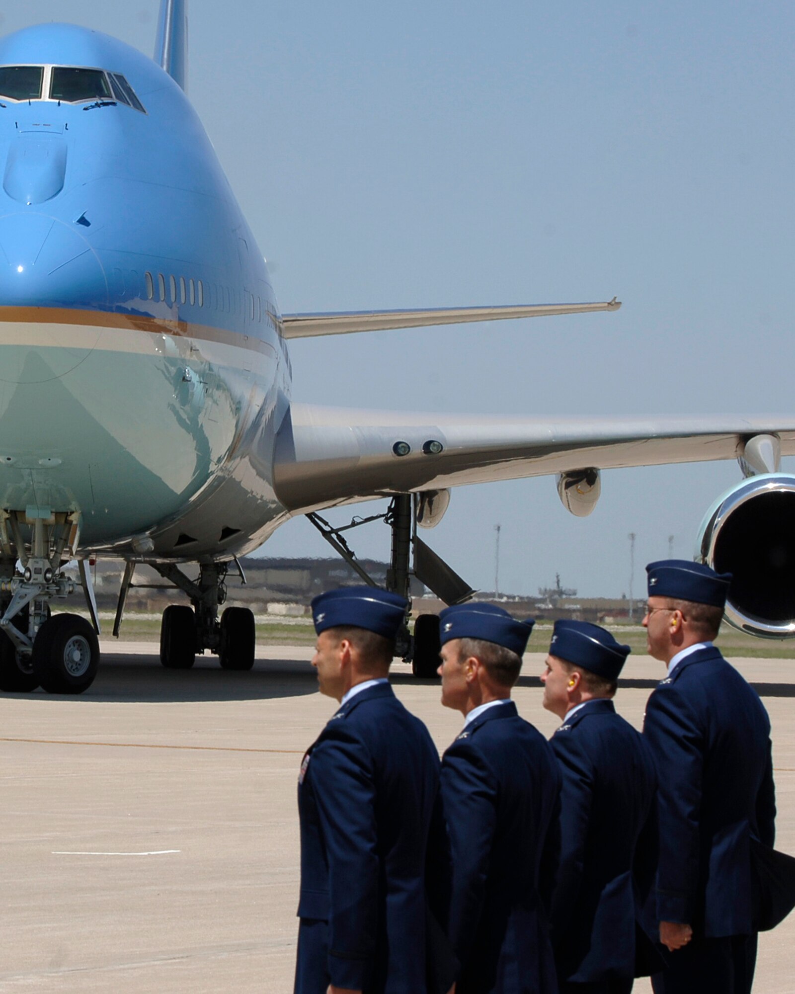 MCCONNELL AIR FORCE BASE, Kan. -- Col. James Vechery, 22nd Air Refueling Wing commander, Col. William Cahoon, 931st Air Refueling Group commander , Col. Michael Foster, 184th Intelligence Wing commander, and Col. Ray LaMarche, 22nd Operations Group commander, stand at attention at the arrival of Air Force One, May 4. (Photo by Airman 1st Class Maria Ruiz)
