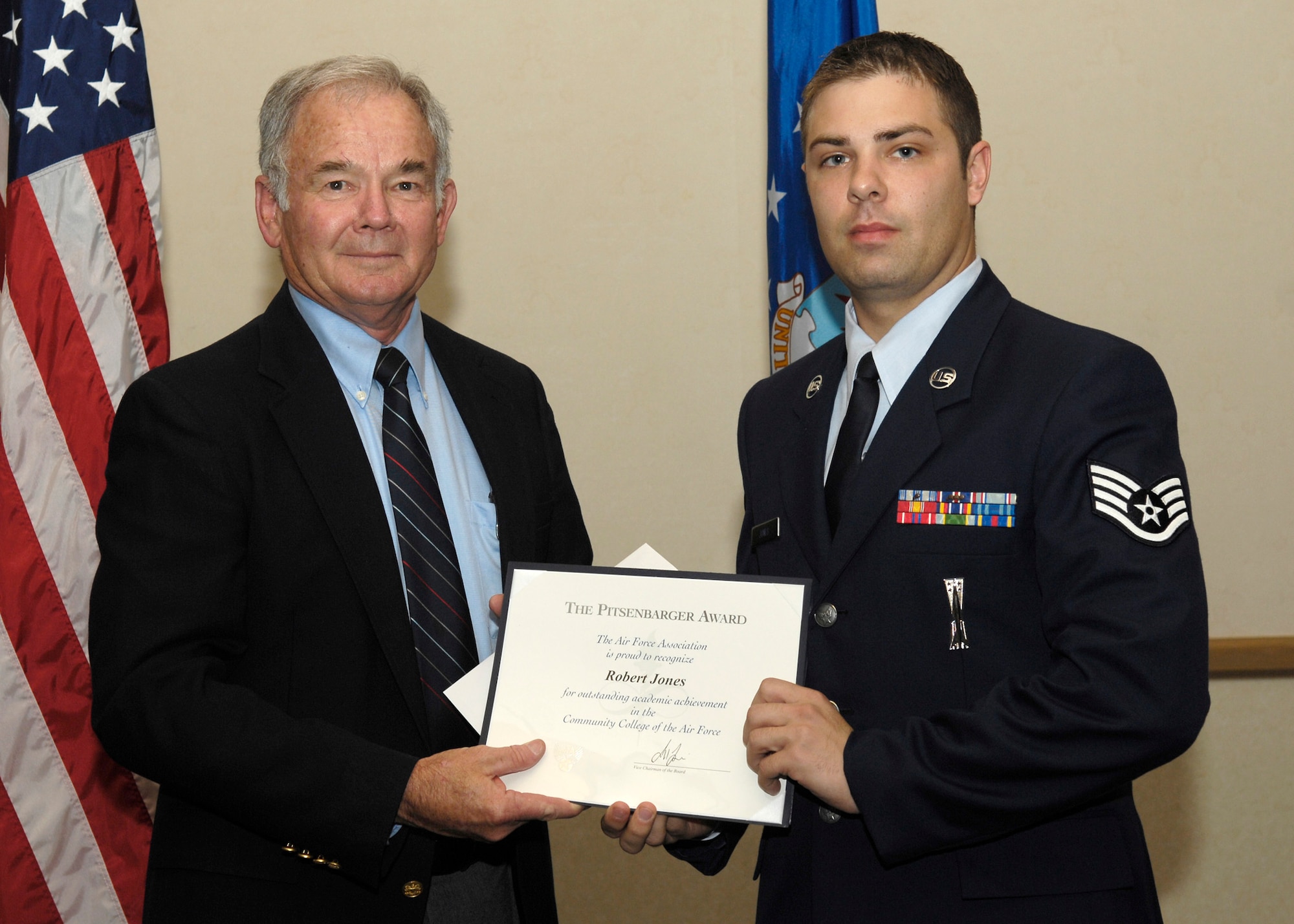 VANDENBERG AIR FORCE BASE, Calif. -- Retired Col. Dave Richardson, president of the Robert H. Goddard chapter of the Air Force Association, presents Staff Sgt. Robert Jones with the Pitsenbarger Award. This academic achievement award for Community College of the Air Force comes with a $500 scholarship from the National Air Force Association, as well as a $100 scholarship from the local chapter. (U.S. Air Force photo / Senior Airman Brian Boyette) 