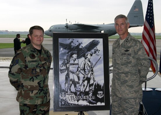 NIAGARA FALLS AIR RESERVE STATION, N.Y. - Staff Sgt. Daniel Lanphear (left), Air Force Reserve and Maj. Gen. Robert Knauff, commander of the New York Air National Guard pose in front of Staff Sgt. Lanphear's hand-sketched artwork which portrays the unity between the Guard and Reserve at Niagara.  The Frontiersman on the left side of the artwork represents the 914th Airlift Wing (AFRC) and the Minuteman on the right represents the 107th Airlift Wing (NYANG).  Standing over Niagara Falls, they symbolize Citizen Airmen united in defense of our nation.  The C-130 represents the units' combined combat flying mission and this artwork commemorates the first ever Reserve/Guard C-130 association.  (U.S. Air Force photo / Tech. Sgt. Christopher Boswell)