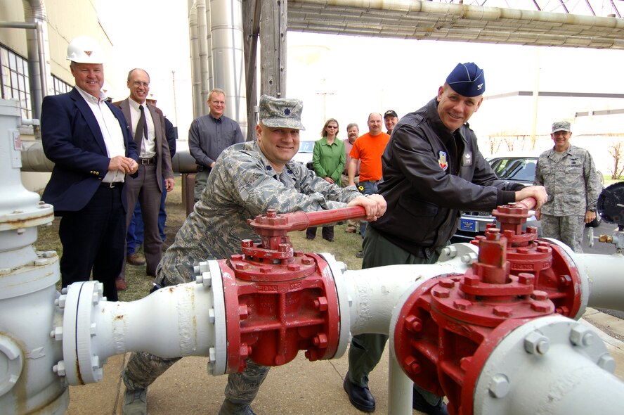 MINOT AIR FORCE BASE, N.D. -- Col. Joel Westa, 5th Bomb Wing commander (right), and Lt. Col. Brian May, 5th Civil Engineering Squadron commander shut off the main gas line into the 51-year-old heat plant here April 30.  The heat plant started operation in June of 1957 and was one of the first buildings completed on base. (U.S. Air Force photo by Airman First Class Kelly Timney)