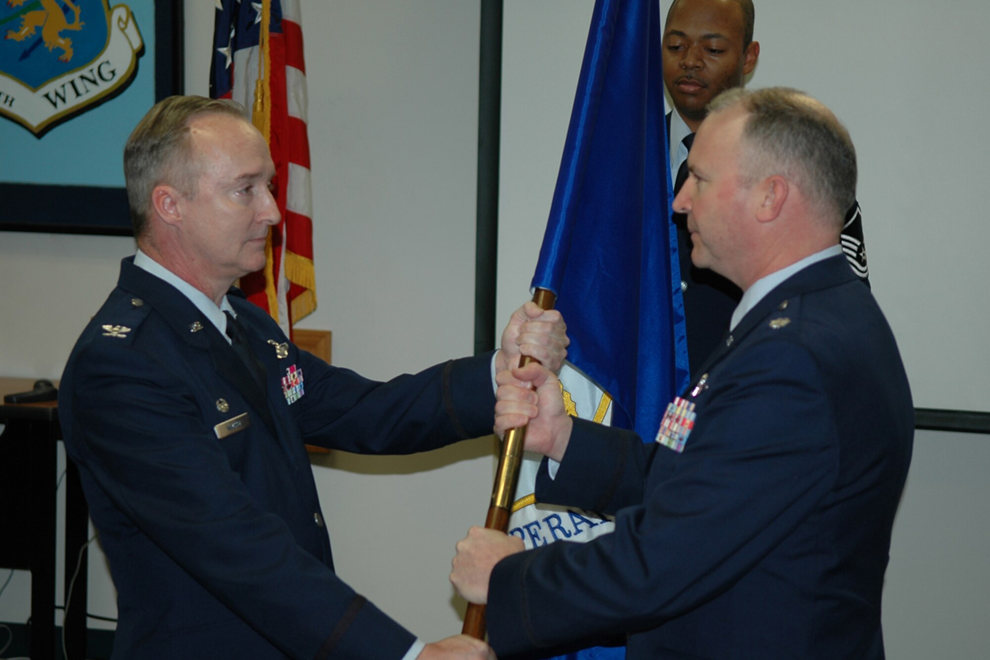 Col. Edmund D. Walker, wing commander, presents the 917th Operations Group flag to Lt. Col. Robert J. Nordberg ll during the change of command cermomy at the wing auditorium, Sunday, May 4, 2008. Colonel Nordberg assumed command of the group from Col. Ozzie H. Gorbitz, who leaves the wing to assume a position at Tenth Air Force. (US Air Force photo/Tech. Sgt. Jeffrey S. Walston) 