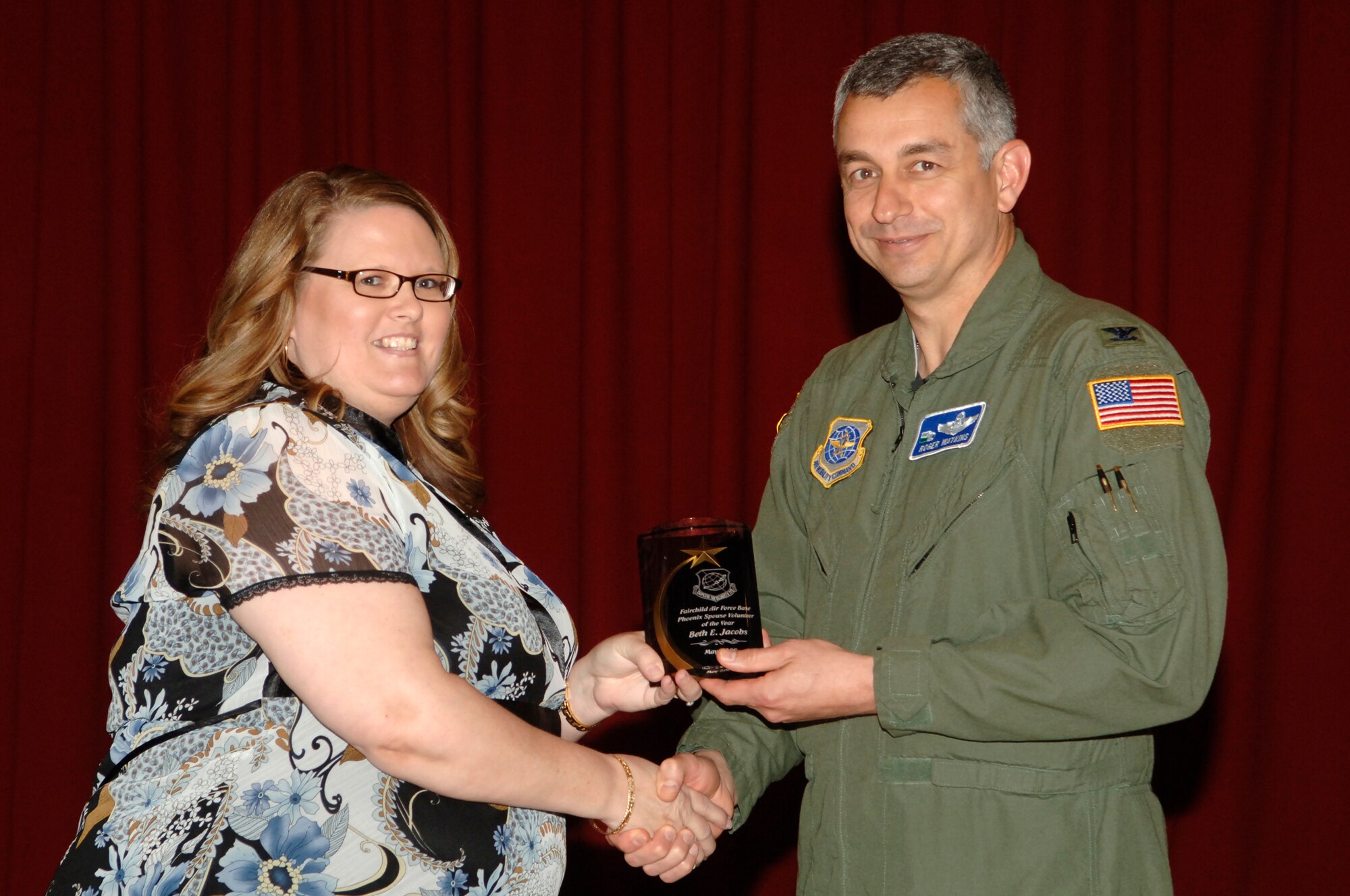 FAIRCHILD AIR FORCE BASE, Wash. – Beth Jacobs accepts the Pheonix Spouse Volunteer of the Year award, presented by Col. Roger Watkins, 92nd Air Refueling Wing vice commander, at Club Fairchild May 1. (U.S. Air Force photo / Staff Sgt. Chad Watkins)