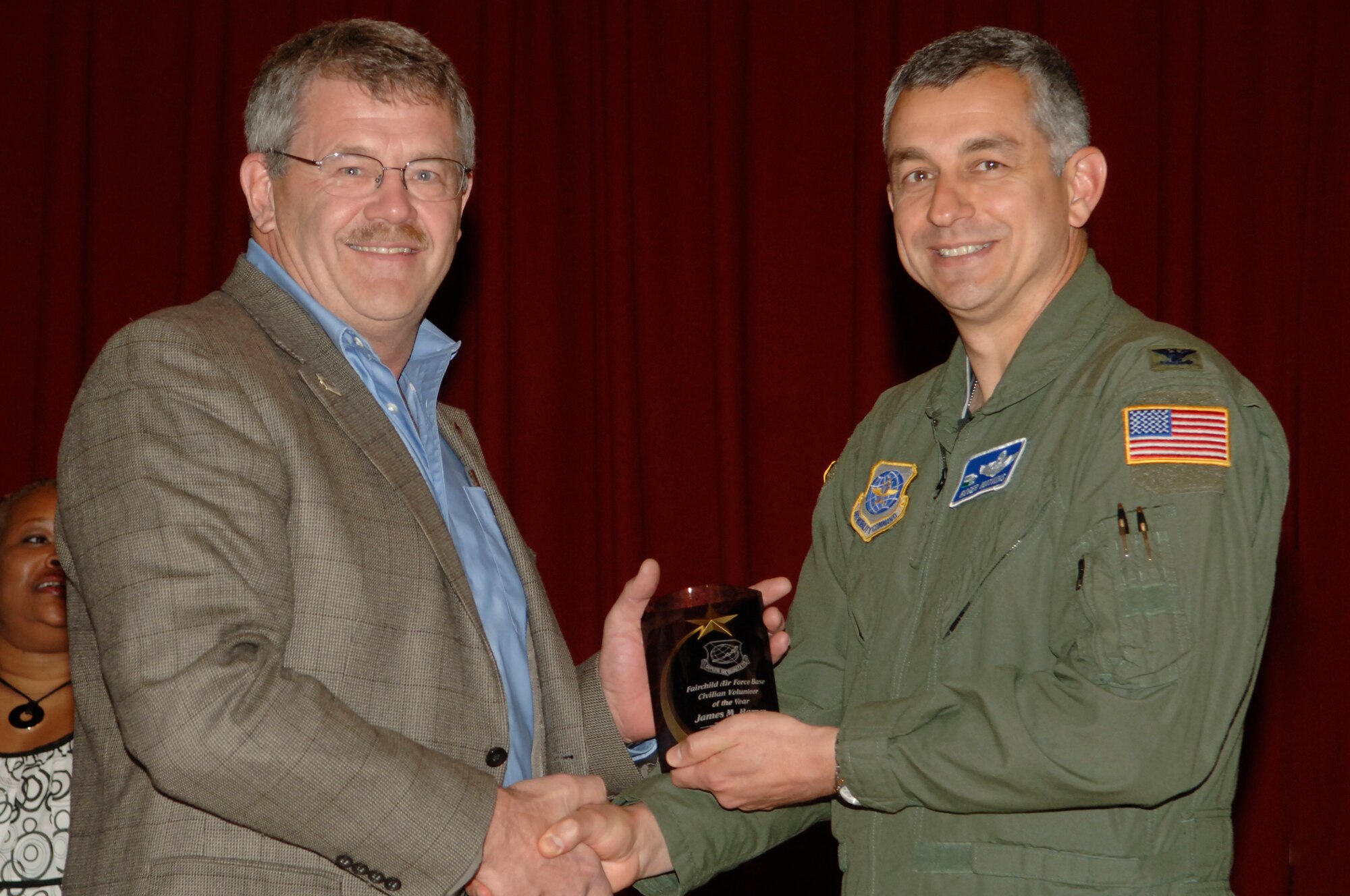 FAIRCHILD AIR FORCE BASE, Wash. – Col. Roger Watkins, 92nd Air Refueling Wing vice commander, presents the Civilian Volunteer of the Year Award  to James Harper at Club Fairchild May 1. (U.S. Air Force photo / Staff Sgt. Chad Watkins)