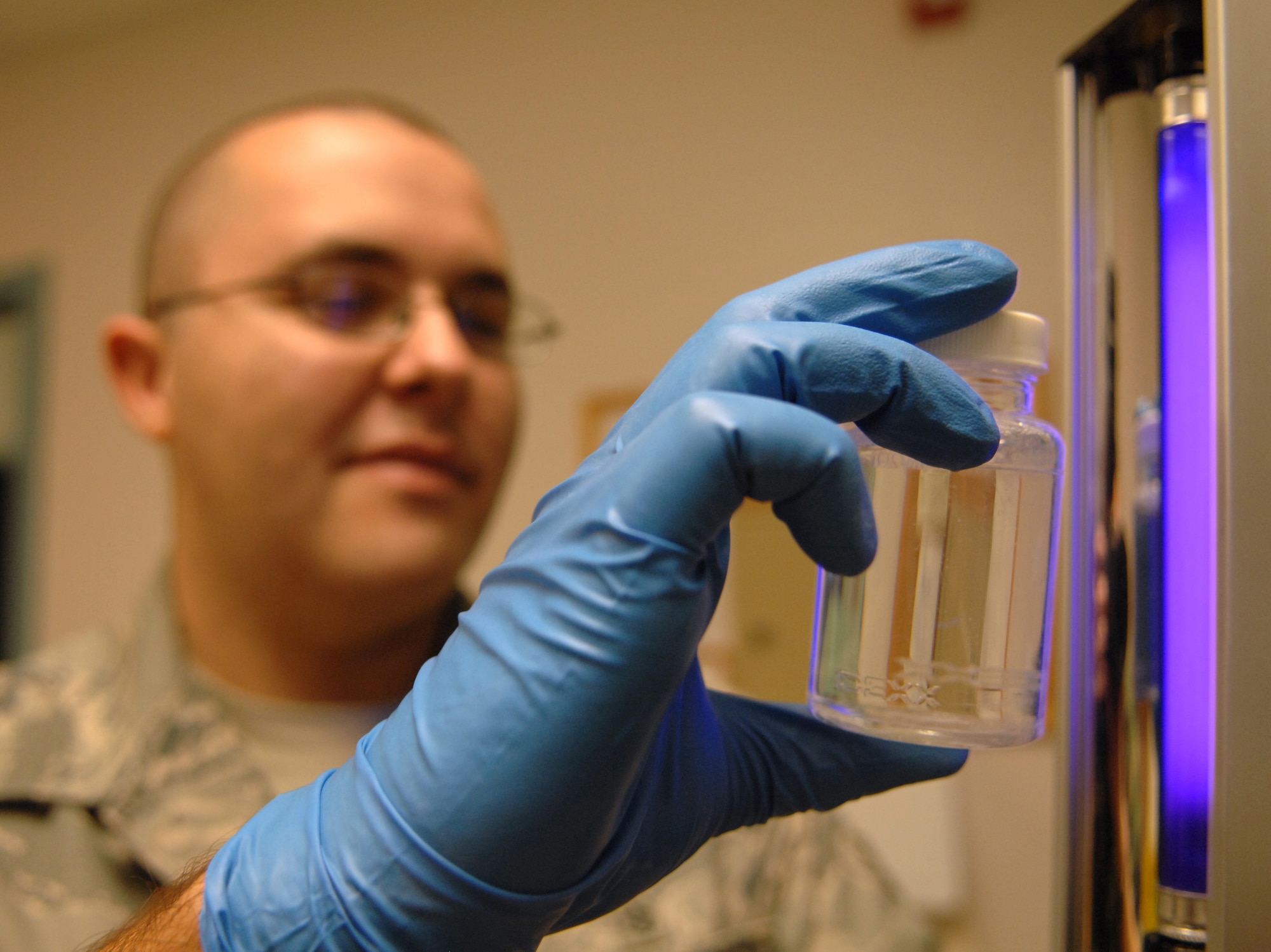HOLLOMAN AIR FORCE BASE, N.M. -- Airman 1st Class Nicholas Martin, a 49th Aeromedical Dental Squadron bioenvironmental engineering technician, does a bacterial logical analysis on the drinking water at the medical clinic here May 5. This test is performed with a black light to test for Escherichia coli (E. coli) in the water. (U.S. Air Force photo by Airman Sondra M. Wieseler)