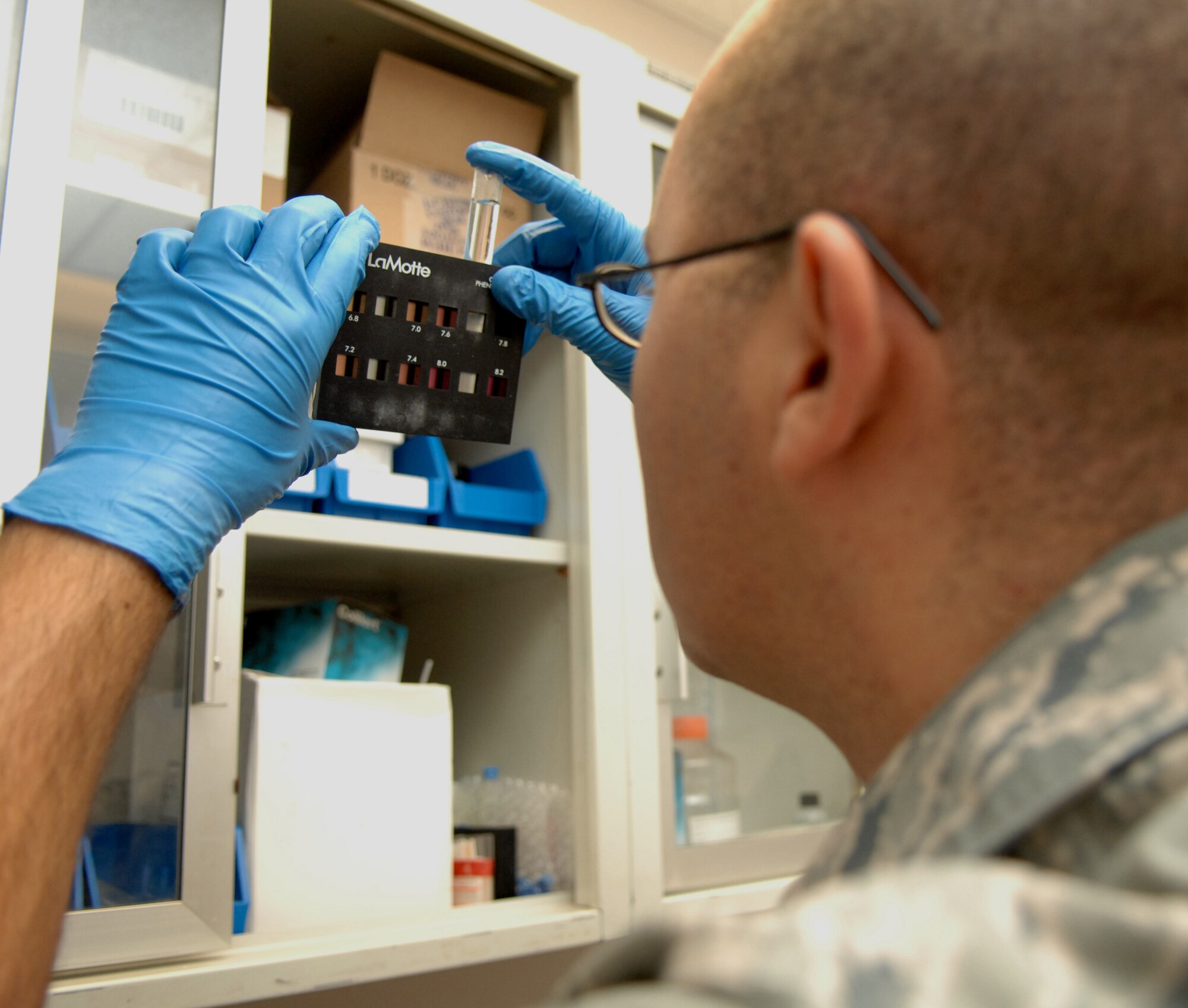 HOLLOMAN AIR FORCE BASE, N.M. -- Airman 1st Class Nicholas Martin, a 49th Aeromedical Dental Squadron bioenvironmental engineering technician, tests drinking water at the medical clinic here May 5. This piece of equipment is called a LaMotte colorimetric comparator and it is used to test the water?s PH levels. (U.S. Air Force photo by Airman Sondra M. Wieseler)