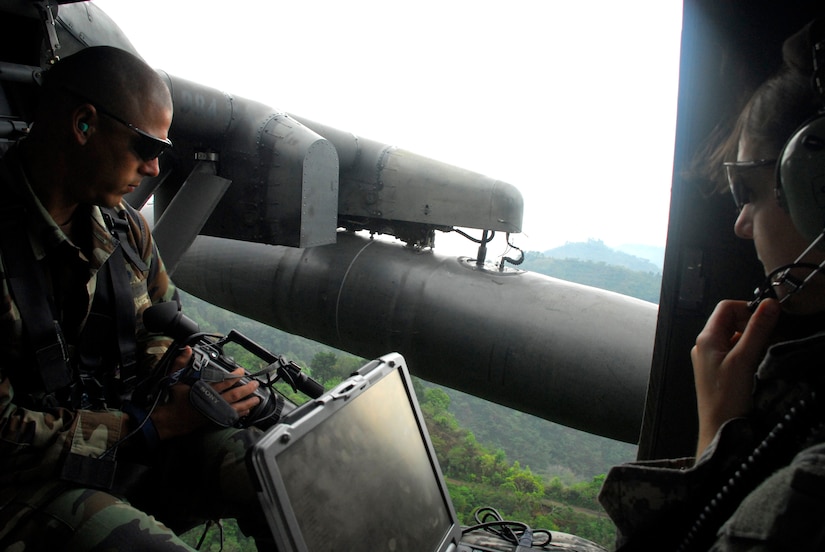 From inside a Joint Task Force-Bravo UH-60 Blackhawk helicopter, Air Force Tech. Sgt. Mike Vaughn and Army Capt. Sarah Williams, JTF-Bravo civil engineers, use the Automated Route Reconnaissance Kit's from gyroscope, global positioning satellite technology, digital video camera and touch-screen computer to capture imagery for use in the disaster exercise Aliadas Humanitarias 2008, a regional disaster relief exercise involving military and civilian agencies occurring here May 5-15.  (U.S. Air Force photo by Tech. Sgt. William Farrow)