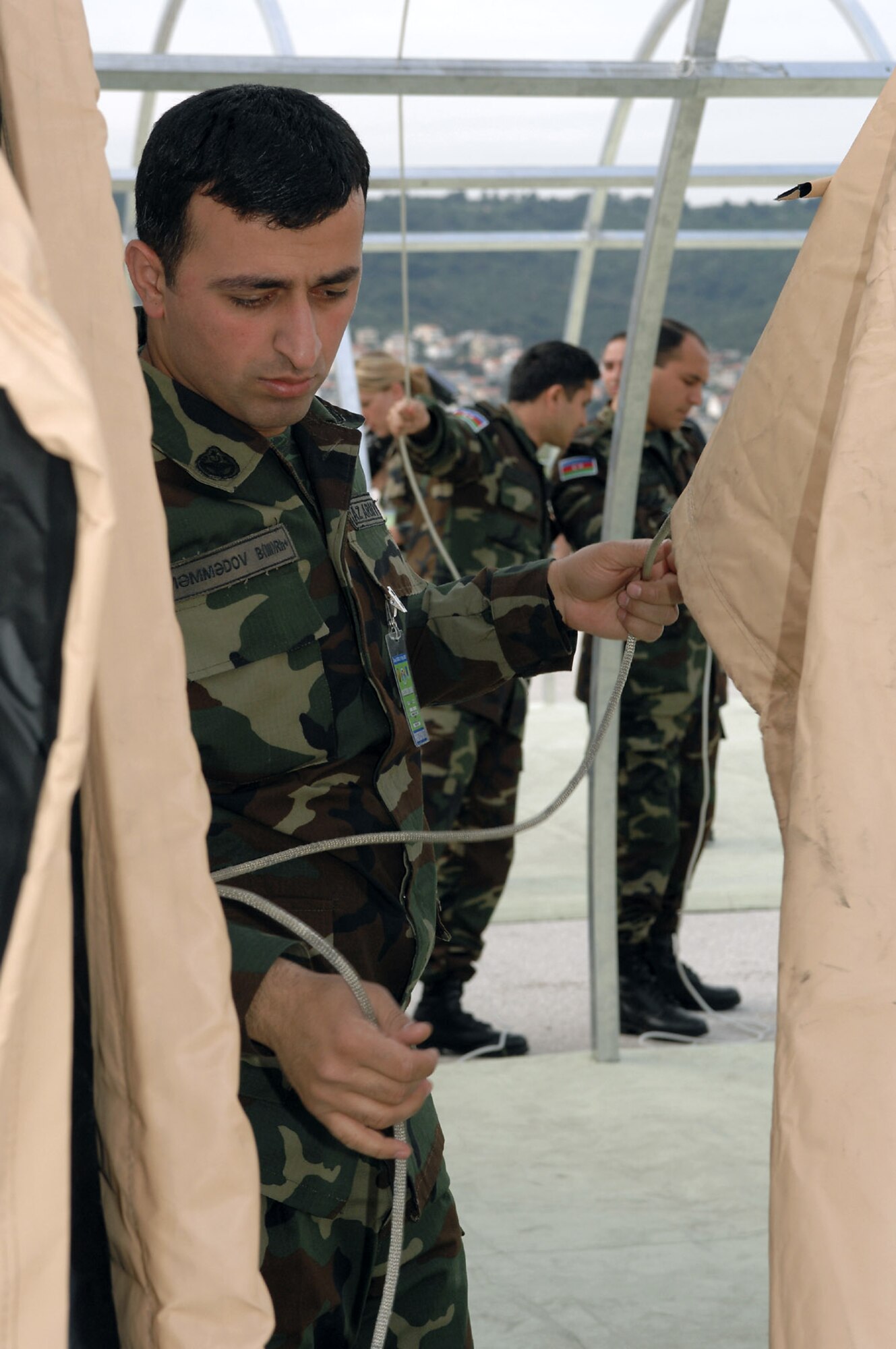 Azerbaijani Army 1st Lt. Elmir Mammadov learns how to assemble an expeditionary medical squadron tent during the 2008 Medical Training Exercise in Central and Eastern Europe May 5 at Dijulje Training Base, Croatia. The course is one of 11 courses offered during the exercise. Fifteen nations are participating in the exercise from May 2 through 14. The exercise focuses on mass-casualty training scenarios and humanitarian aid in response to crises situations, and a Joint Chiefs of Staff regional/multilateral exercise sponsored by U.S. European Command. Croatia officials are hosting the 2008 exercise, which drew about 400 multinationals in support of the Partnership for Peace initiative. (U.S. Air Force photo/Staff Sgt. Kristin Ruleau) 
