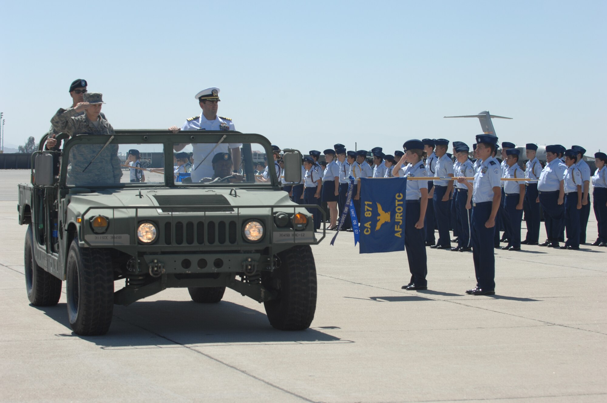 Colonel Pam LeBlanc, 452d Mission Support Group commander, left, reviews the
troops in a 304th Sustainment Brigade Humvee on the flight line at March Air Reserve Base.  Colonel Gregory Maida, 304th Sustainment Brigade commander, and Commander Steve Hartsel, Navy Operations Support Center commander, right, join her in reviewing some 400 cadets from various Southern California schools participated in the event.  (U.S. Air Force photos by Senior Airman Daniel St. Pierre, 4th Combat Camera Squadron)