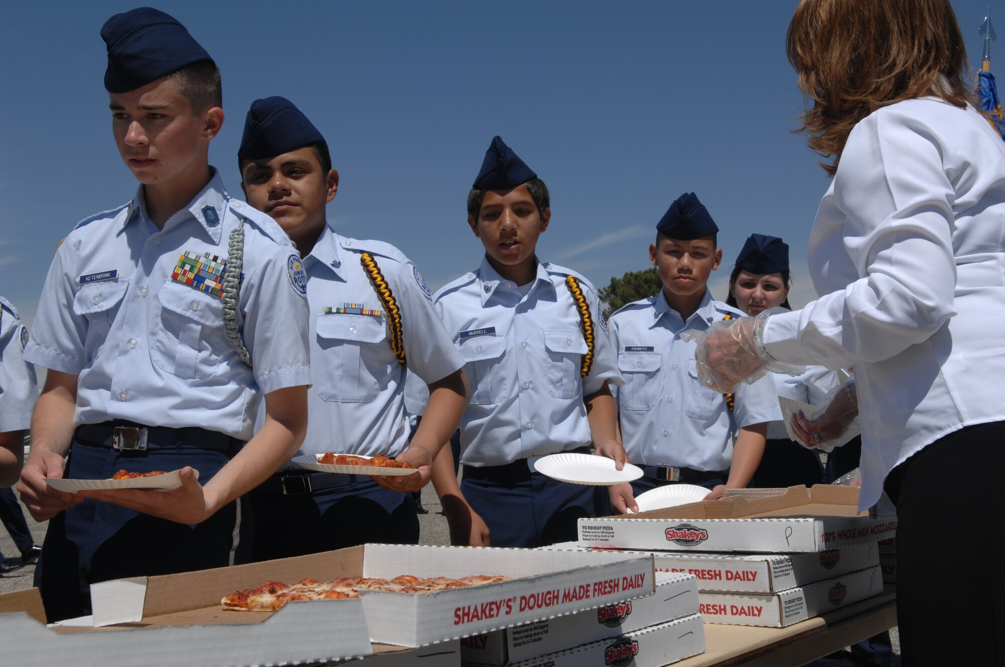 Local community volunteers served a pizza lunch to the cadets after the ceremony on the flight line at March Air Reserve Base.  Some 400 cadets from various Southern California schools participated in the event.  (U.S. Air Force photos by Senior Airman Daniel St. Pierre, 4th Combat Camera Squadron)