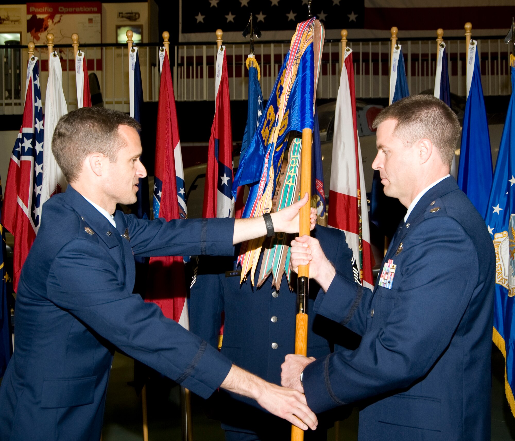 Lt. Col. Gregory Patschke receives his 36th Electronic Warfare Squadron guidon from the Lt. Col. Melvin Peterson, 53d Electronic Warfare Group acting commander, during the 36th EWS change of command ceremony at the Air Armanent Center May 2 at Eglin Air Force Base, Fla.  He took the reins from Lt. Col. John "Hap" Arnold.  U.S. Air Force photo. 