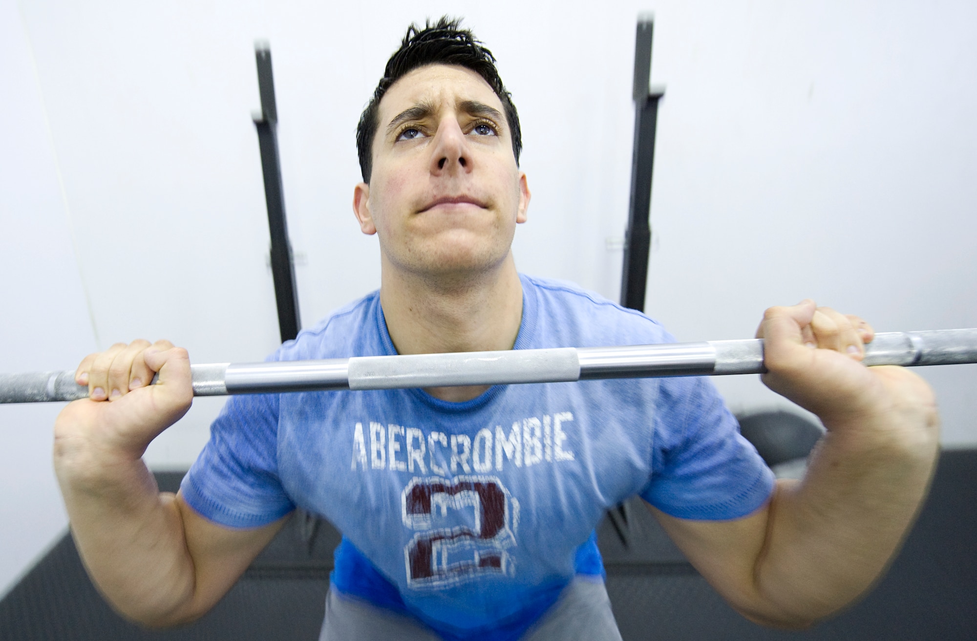 LANGLEY AIR FORCE BASE, Va. -- Staff Sgt. Carlos Gonzales, an F-22A Raptor weapons load team member with the 27th Aircraft Maintenance Unit, does a forward squat thrust during his CrossFit workout April 30. CrossFit is an exercise program that encompasses the entire body. CrossFit is the principle strength and conditioning program for many police academies, military special operations units and hundreds of professional athletes worldwide. (U.S. Air Force photo/Staff Sgt. Samuel Rogers)