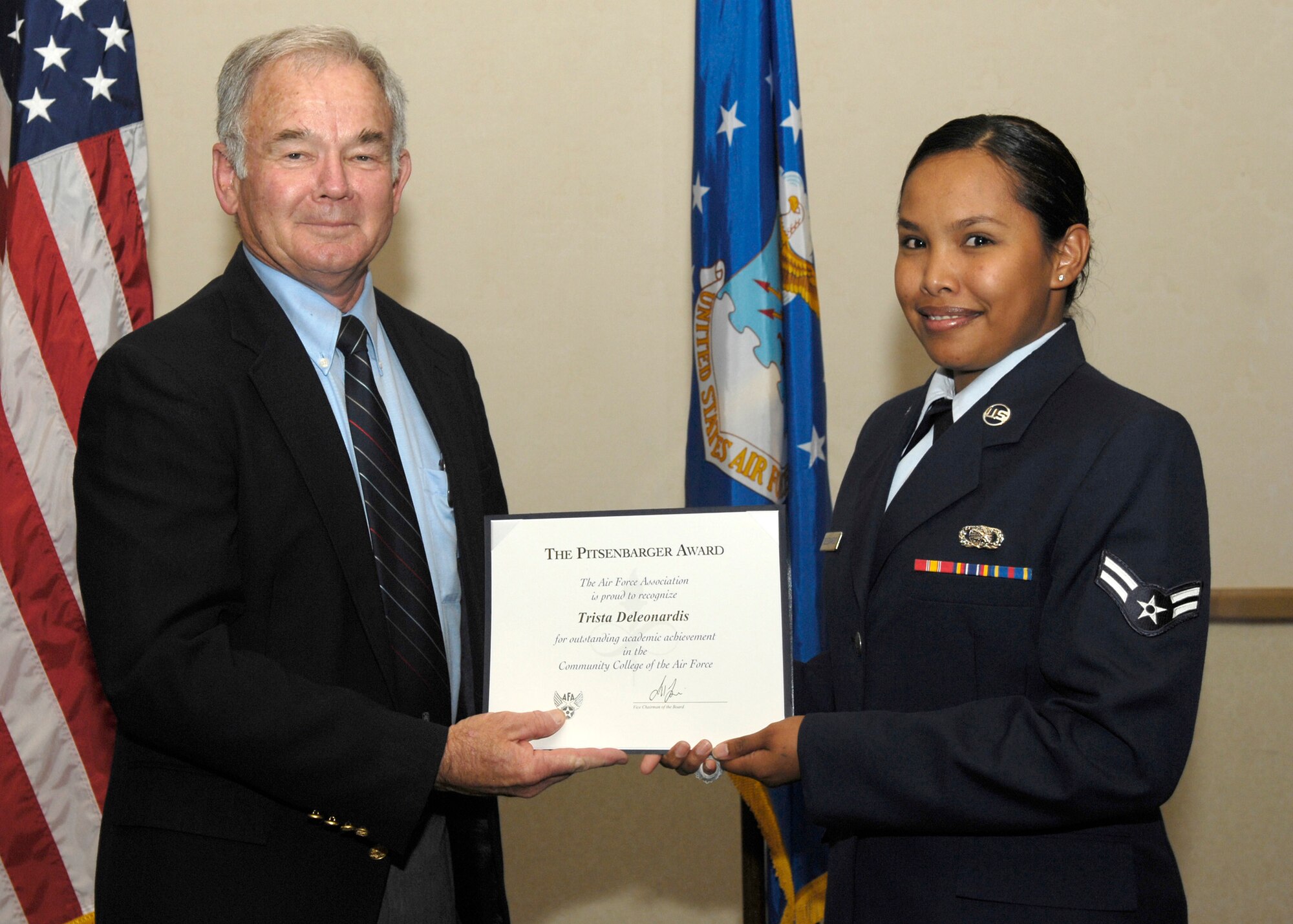 VANDENBERG AIR FORCE BASE, Calif. --  Retired Col. Dave Richardson, president of the Robert H. Goddard chapter of the Air Force Association, presents Airman 1st Class Trista Deleonardis with the Pitsenbarger Award. This academic achievement award for Community College of the Air Force comes with a $500 scholarship from the National Air Force Association, as well as a $100 scholarship from the local chapter. (U.S. Air Force photo / Senior Airman Brian Boyette)