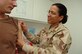 Tech. Sgt. Susan Padilla-Roman, 380th Expeditionary Medical Group non-commissioned officer in charge of primary care, prepares to administer an immunization shot to an Airman at a base in Southwest Asia, May 1st, 2008. Sergeant Padilla-Roman was the 380th Air Expeditionary Wing's Warrior of the Week for the week of May 2, 2008.(U.S. Air Force photo/Senior Airman Levi Riendeau)