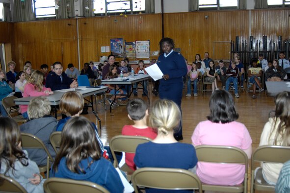 HANSCOM AFB, Mass. – Capt. Cho-Cho Lassey (standing), Legal Assistance chief presents the defense’s case to a jury of fifth grade Hanscom Middle School students during the mock trial of the U.S. vs. Paul Bunyan on April 30. The mock trial was sponsored by the ESC Legal Office to instill an understanding and interest in America’s legal system in commemoration of the 50th anniversary of Law Day. (U.S. Air Force photo by Linda LaBonte Britt)