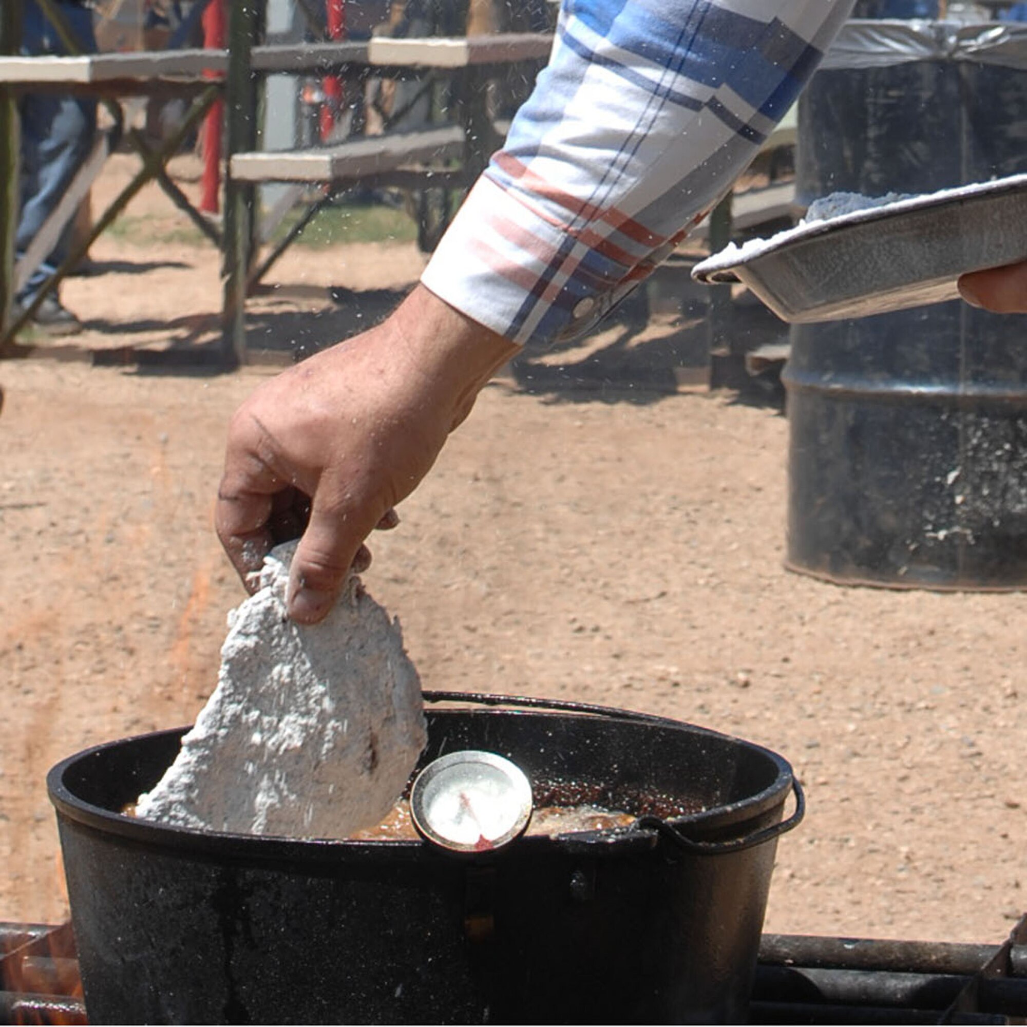 CANNON AIR FORCE BASE, N.M.- - Rickie Denison drops his fries chicken fried steak  into a Dutch oven at the Chuck Wagon Cook Off. The Cook Off took place at Curry County Fairgrounds in on May 3 in Clovis, N.M. (U.S. Air Force photo by Airman Maynelinne De La Cruz)
