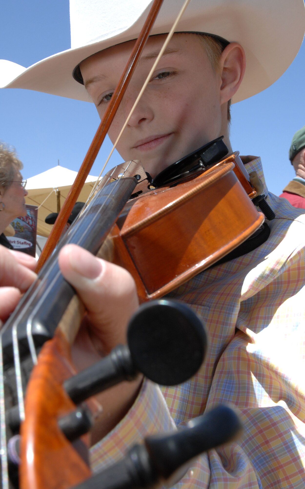 CANNON AIR FORCE BASE, N.M. - -Coby Carter plays his violin for friends and family at the Chuck Wagon Cook Off May 3.  Toby has been playing the violin for more than five years. (U.S. Air Force photo by Airman Maynelinne De La Cruz)