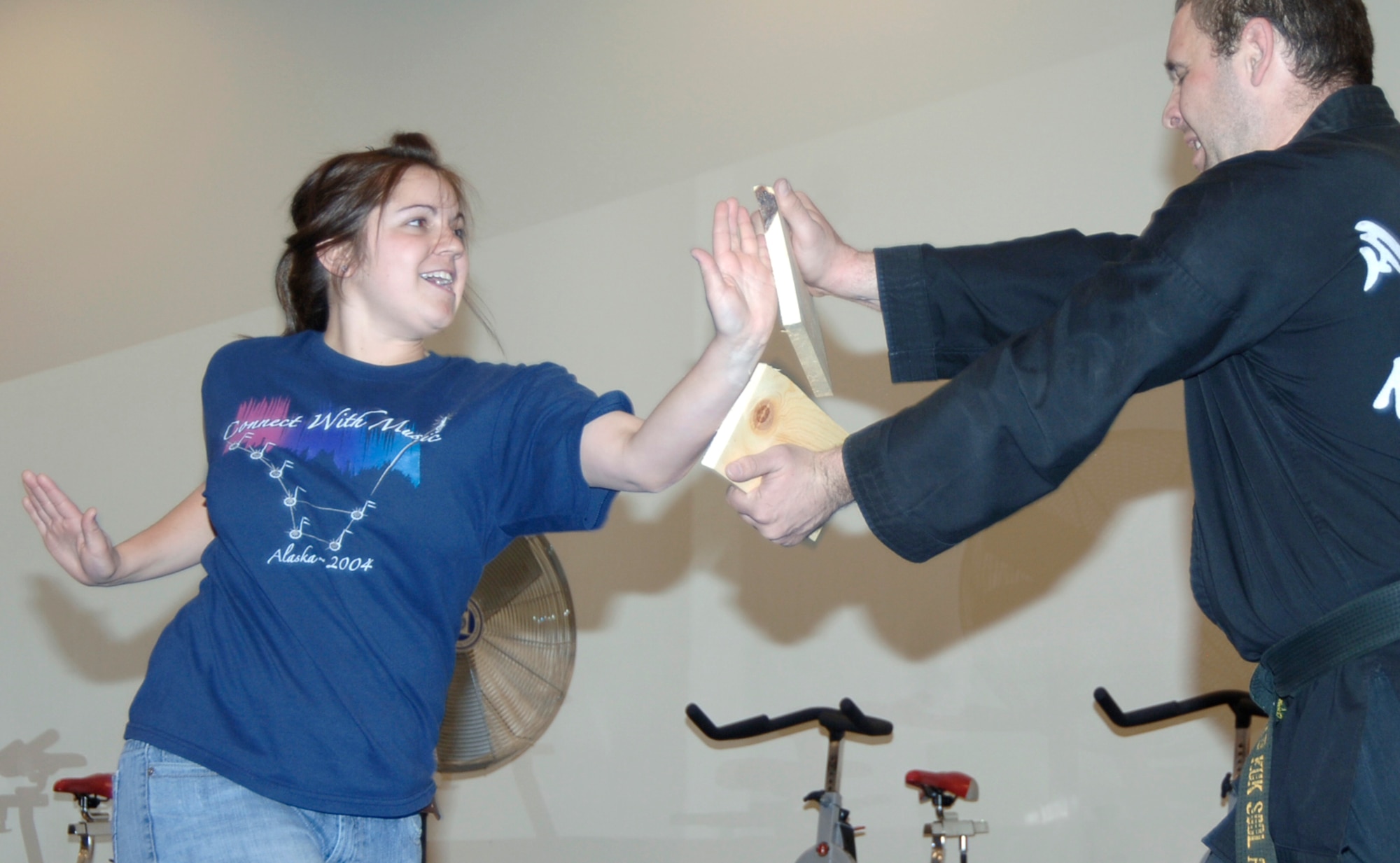 MOUNTAIN HOME AIR FORCE BASE, Idaho -- (Left) Cydney Viall breaks a board held by Michael Poulin, 366th Civil Engineer draftsman and Kuk Sool Won martial arts teacher, during a self-defense class at the base fitness center April 29. The classes, which were held throughout April for adults and on April 29 for teenagers, were sponsored by the base's sexual assault response coordinator, or SARC, office and were part of the base's sexual assault awareness month. (U.S. Air Force photo/Airman 1st Class Samantha S. Crane)