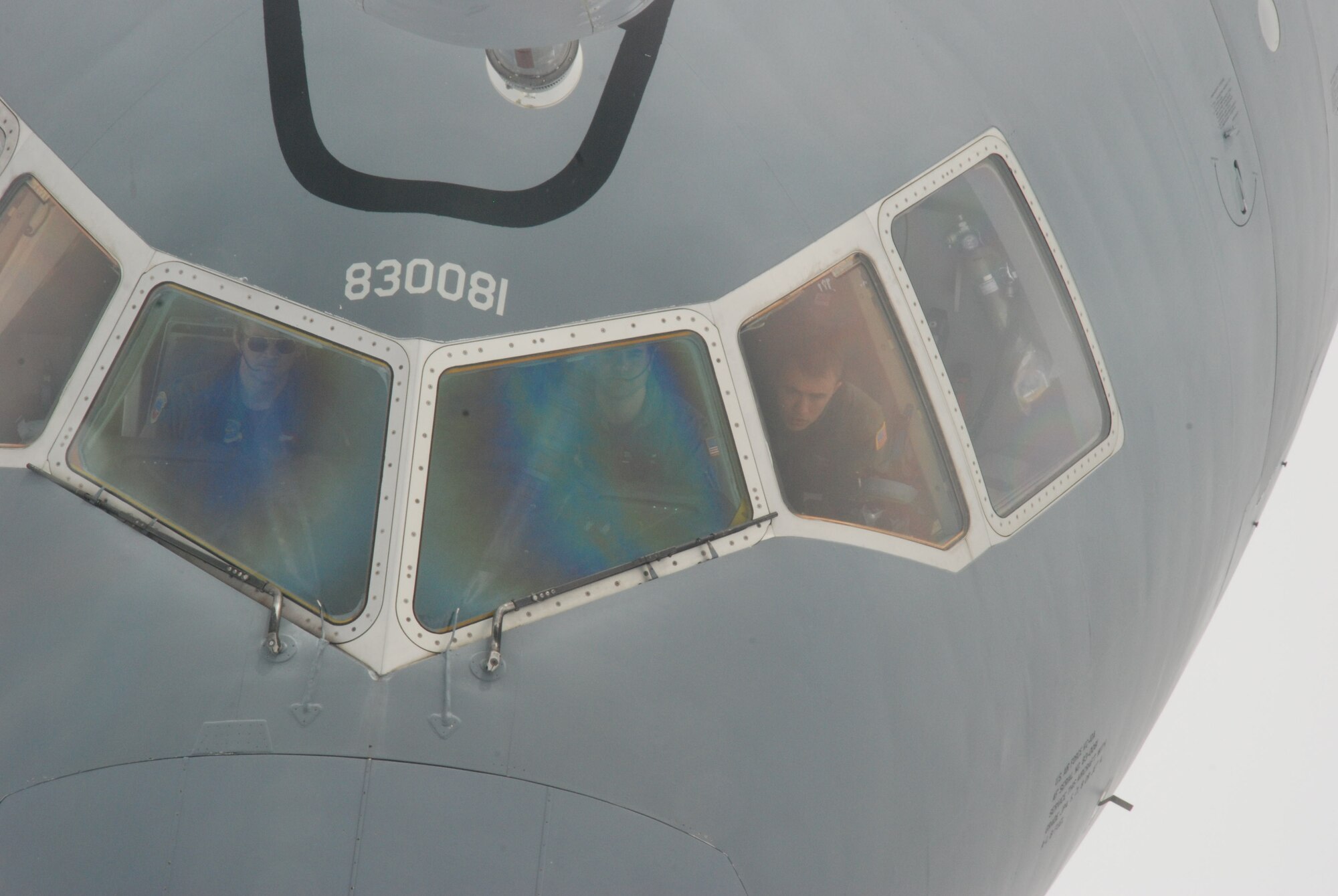 Aircrew on receiving aircraft look up at boom in training mission over the Atlantic Ocean.