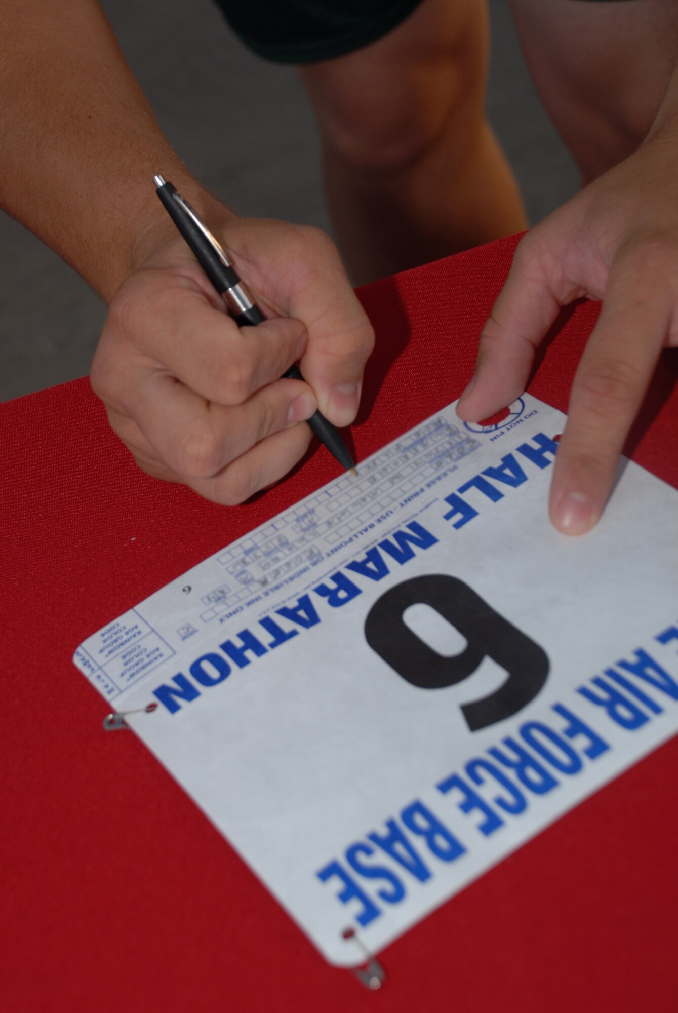 A marathon participant fills out his entry forms before starting the half marathon held at the Base Fitness Center, May 3. The half marathon consisted of more than 50 Airmen, retirees, and children from Luke Air Force Base. (U.S. Air Force photo/Airman 1st Class Tracie Forte)