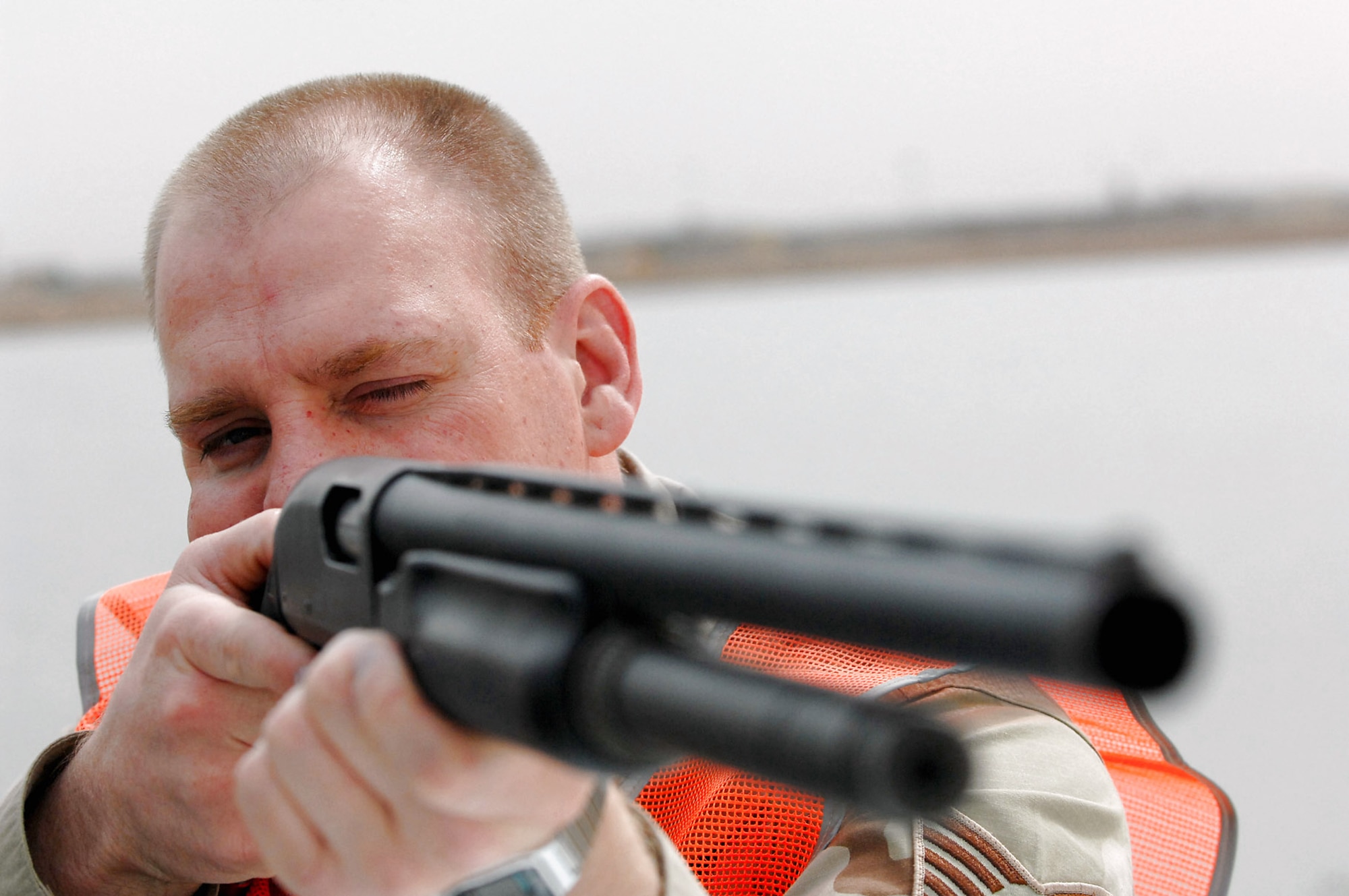 Tech. Sgt. David Young takes aim at a group of gulls to reduce the number of birds at Balad Air Base, Iraq. Collisions between flying birds and aircraft can severely damage aircraft and endanger the lives of pilots. To reduce the number of collisions, members of the 332nd Air Expeditionary Wing Safety Office depredate the birds on the base. On May 3, the remains of whole, depredated birds were shipped from the base to the Smithsonian Institution, National Museum of Natural History, Feather Identification Laboratory in Washington, D.C., to be analyzed by scientists there. This marks the first shipment of whole bird remains to be sent from Iraq to the Smithsonian. Sergeant Young is the 332nd Air Expeditionary Wing noncommissioned officer in charge of flight safety deployed from Elmendorf Air Force Base, Alaska. (U.S. Air Force photo/Senior Airman Julianne Showalter) 
