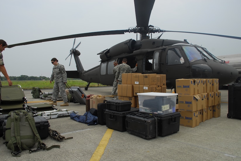 Members of Joint Task Force-Bravo unload a UH-60 helicopter at Comalapa Air Base, El Salvador May 4 in preparation for Fuerzas Aliadas Humanitarias 2008, the U.S. Southern Command and Salvadoran Ministry of Defense-sponsored disaster relief exercise. (U.S. Air Force photo by Tech. Sgt. William Farrow)