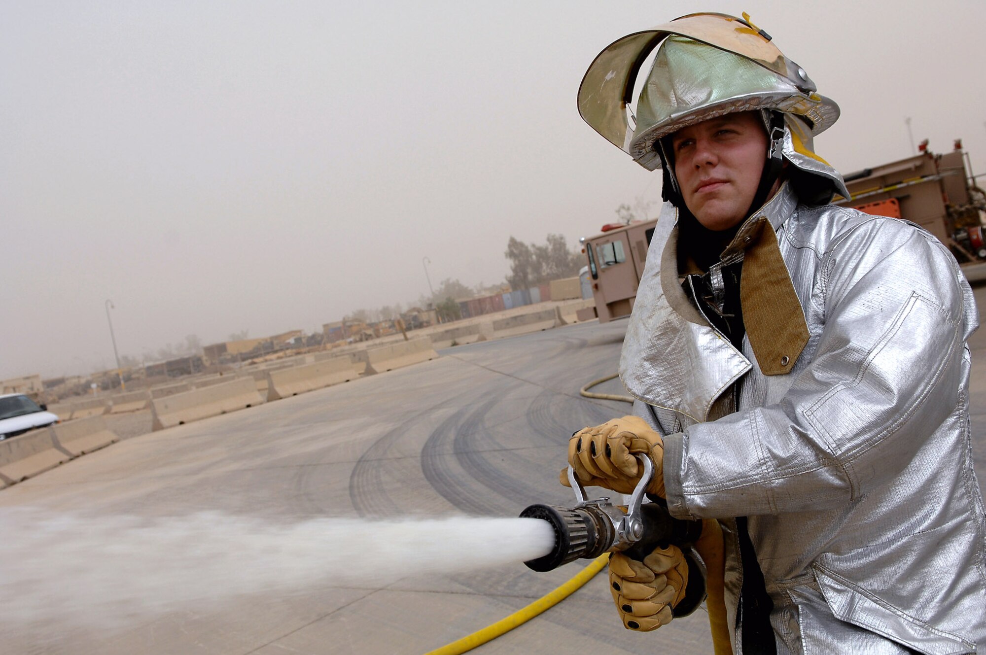 Airman 1st Class Adam Baumgardner conducts hose advancement and pump training April 29 at Balad Air Base, Iraq. The fire station on Balad AB is composed of both Army and Air Force members who work jointly to respond to fires and emergency situations. This allows for seamless coordination of their efforts when responding to emergencies. Airman Baumgardner is a 332nd Expeditionary Civil Engineer Squadron firefighter deployed from Malmstrom Air Force Base, Mont. (U.S. Air Force photo/Senior Airman Julianne Showalter) 
