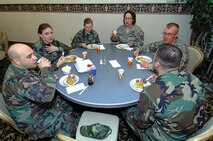 MINOT AIR FORCE BASE, N.D. -- Airmen from the 5th Maintenance Operations Squadron enjoy a home-cooked breakfast consisting of pancakes and sausage made by the chief's group here May 2.  The chief's group provides this breakfast twice a year Airmen and their families.  (U.S. Air Force photo by Airman 1st Class Kelly Timney)