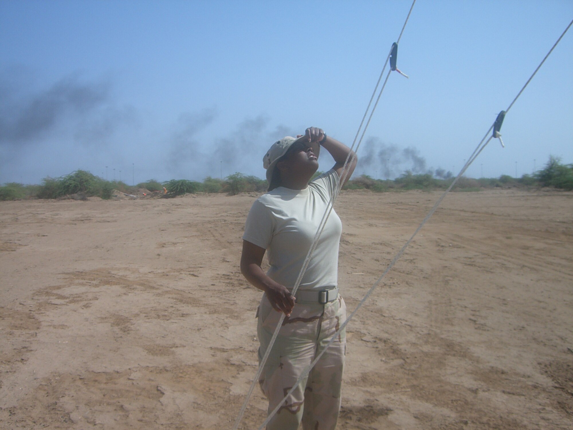 SEYMOUR JOHNSON AIR FORCE BASE, N.C. -- Staff Sgt. Veronica Jefferson checks out some communication equipment in the heat of an African desert. Sgt. Jefferson is currently deployed to Djibouti as a communications systems journeyman. She is a Reservist with the 916th Communications Squadron.