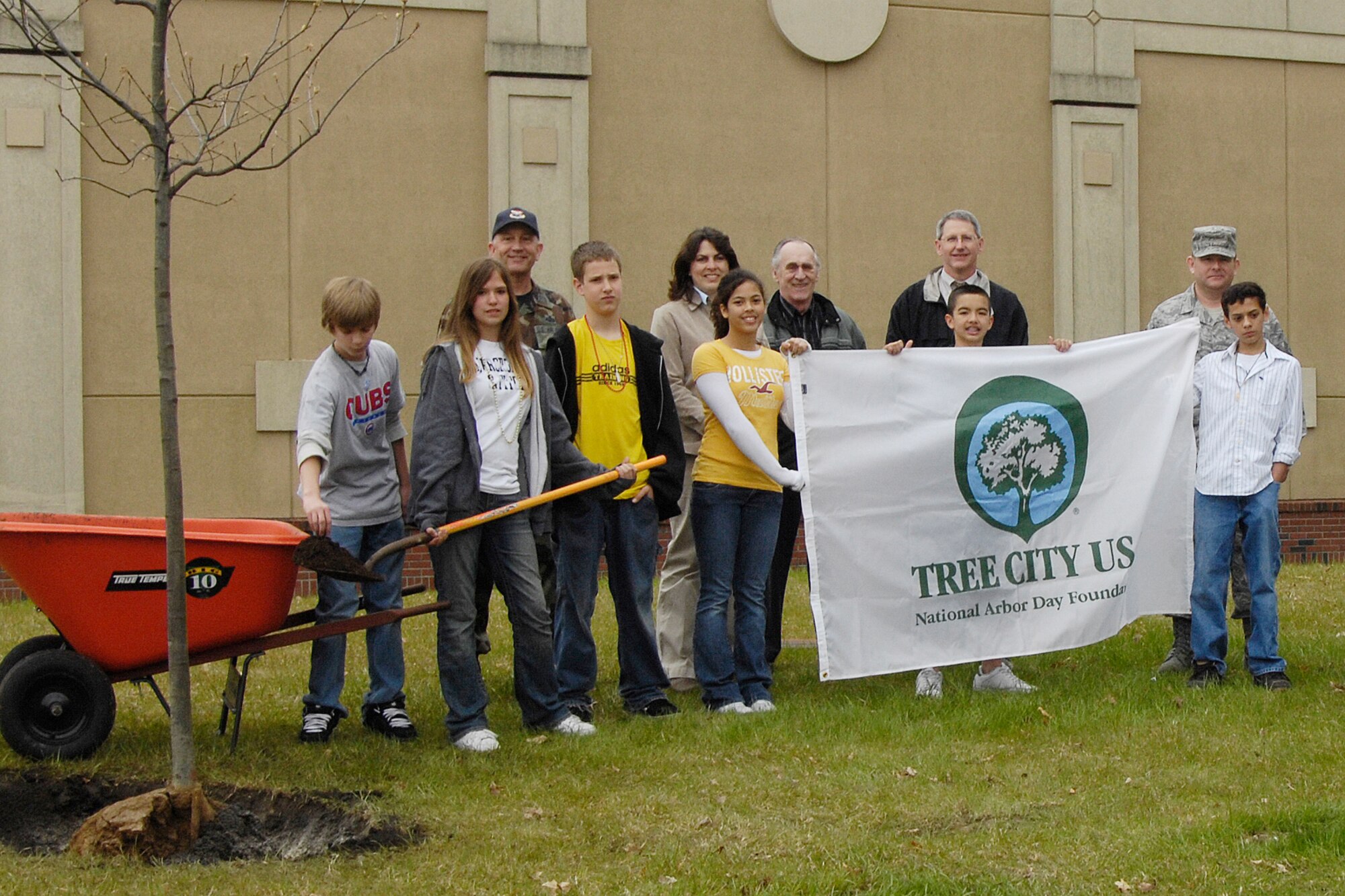 HANSCOM AFB, Mass. – Students from the Hanscom Middle School joined Col. Robert Boyles, 66th Mission Support Group commander and members of the 66th Mission Support Group, Civil Engineering in celebrating Arbor Day on May 2. Pictured with the middle school students are (back row from left to right) Colonel Boyles, Virginia Clor, IAP programmer, Jim Dolan, IAP engineering manager, Chris Perkins, base civil engineer and Chief Master Sergeant Michael McCoy, 66 MSG superintendent. As part of the celebrations the group planted two trees at the Hanscom Fitness and Sports Center, an American Elm which is the State of Massachusetts tree, and a Red Oak, in honor of our National tree. For the 21st consecutive year Hanscom has maintained its Tree City USA status. (U.S. Air Force photo by Linda LaBonte Britt)

